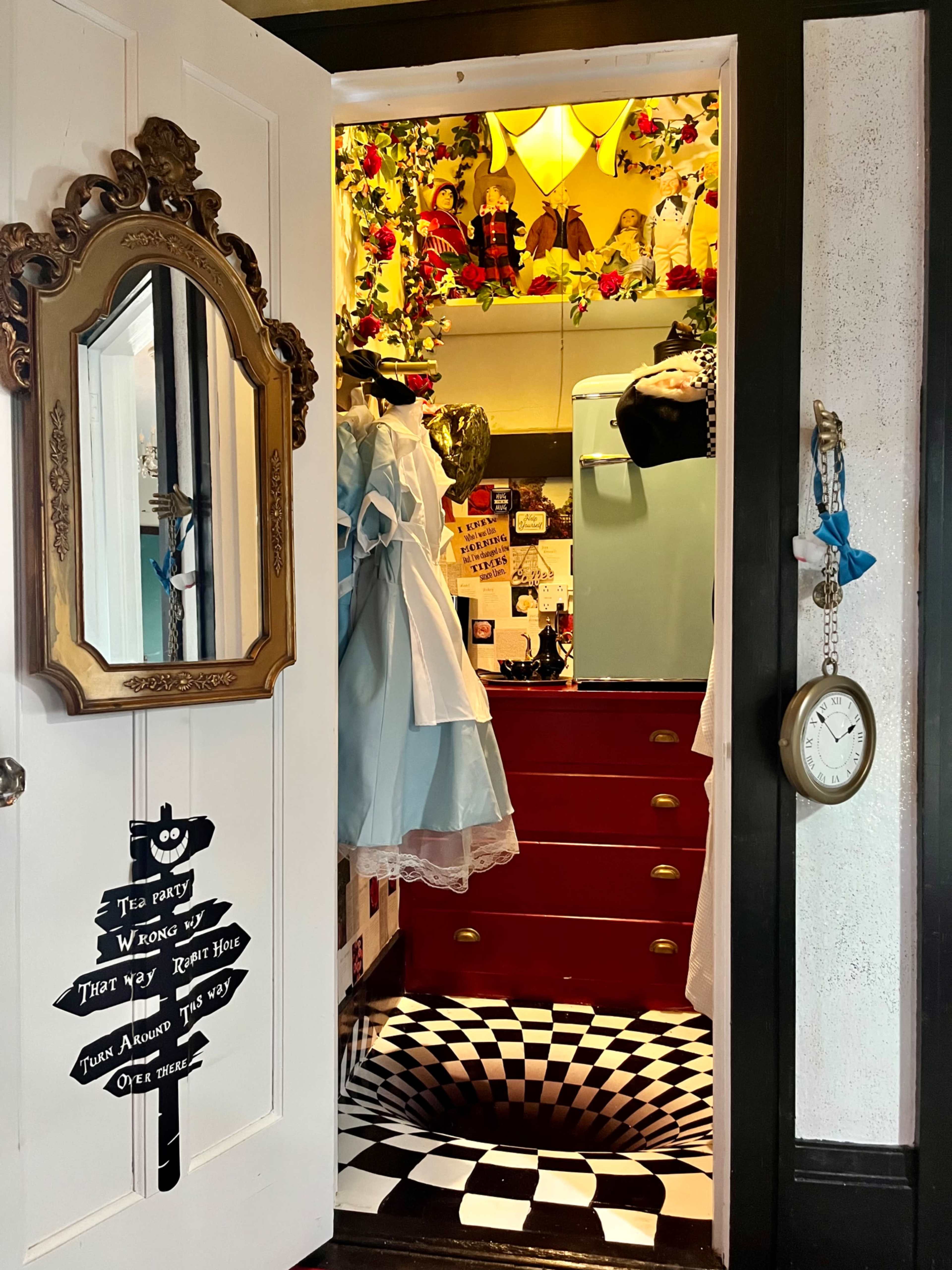The image shows an open closet with a mirror, colorful decorations, a blue dress, and a checkered floor pattern.