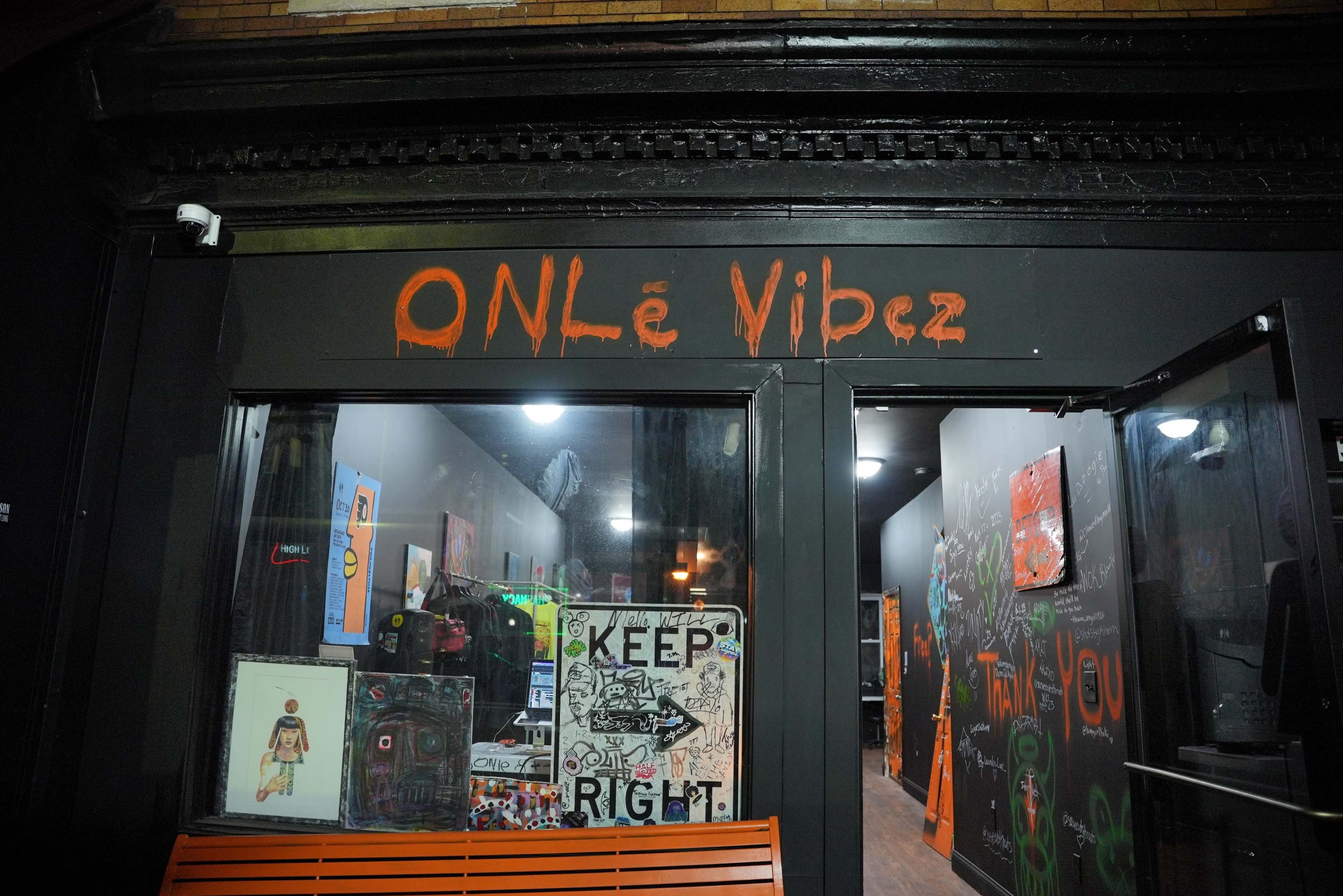 The storefront features a sign that reads "ONLé Vibez," with a display of artwork and signage visible through the large window.
