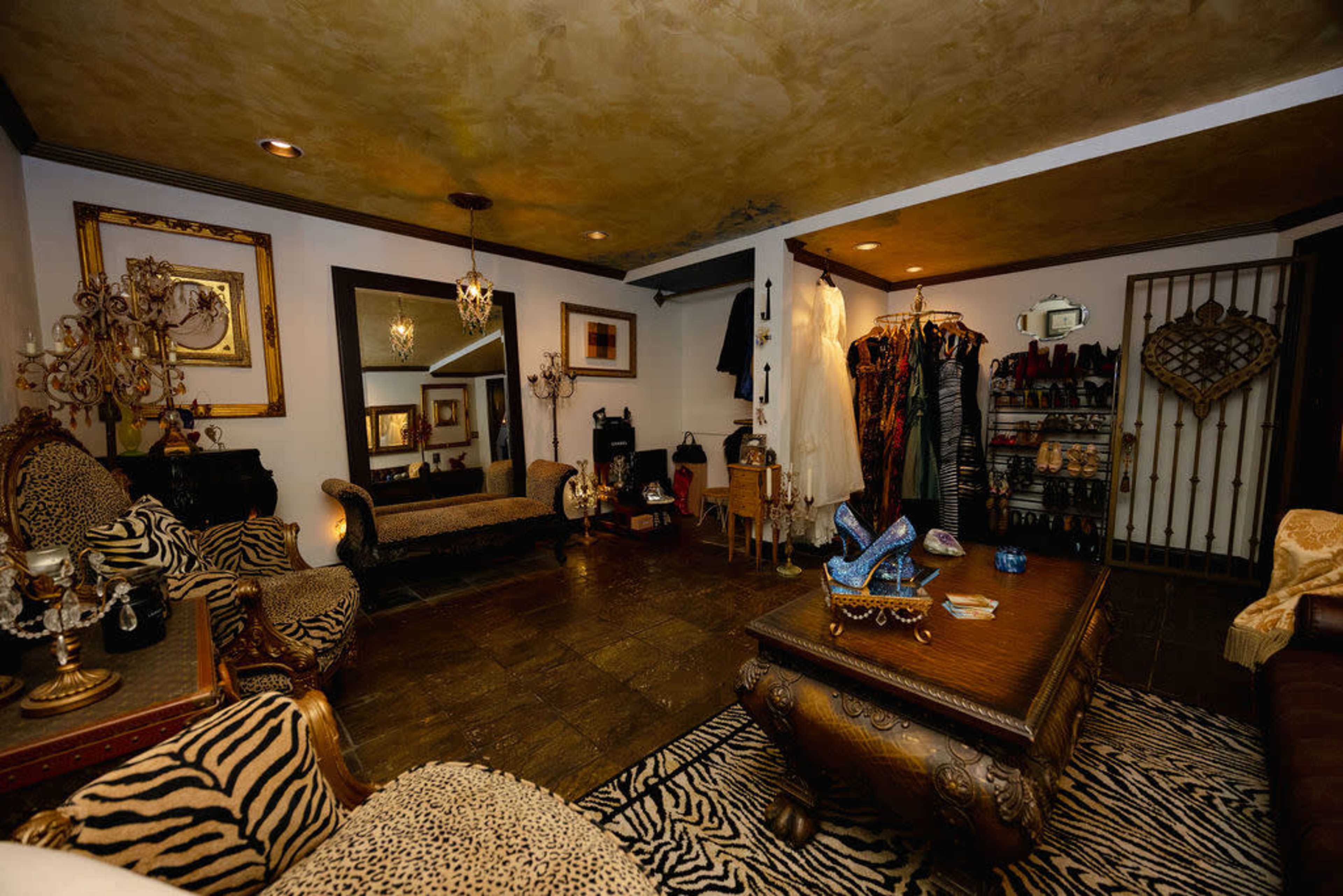 The image depicts a stylish boutique interior featuring ornate furniture, animal print decor, and a display of clothing and accessories.