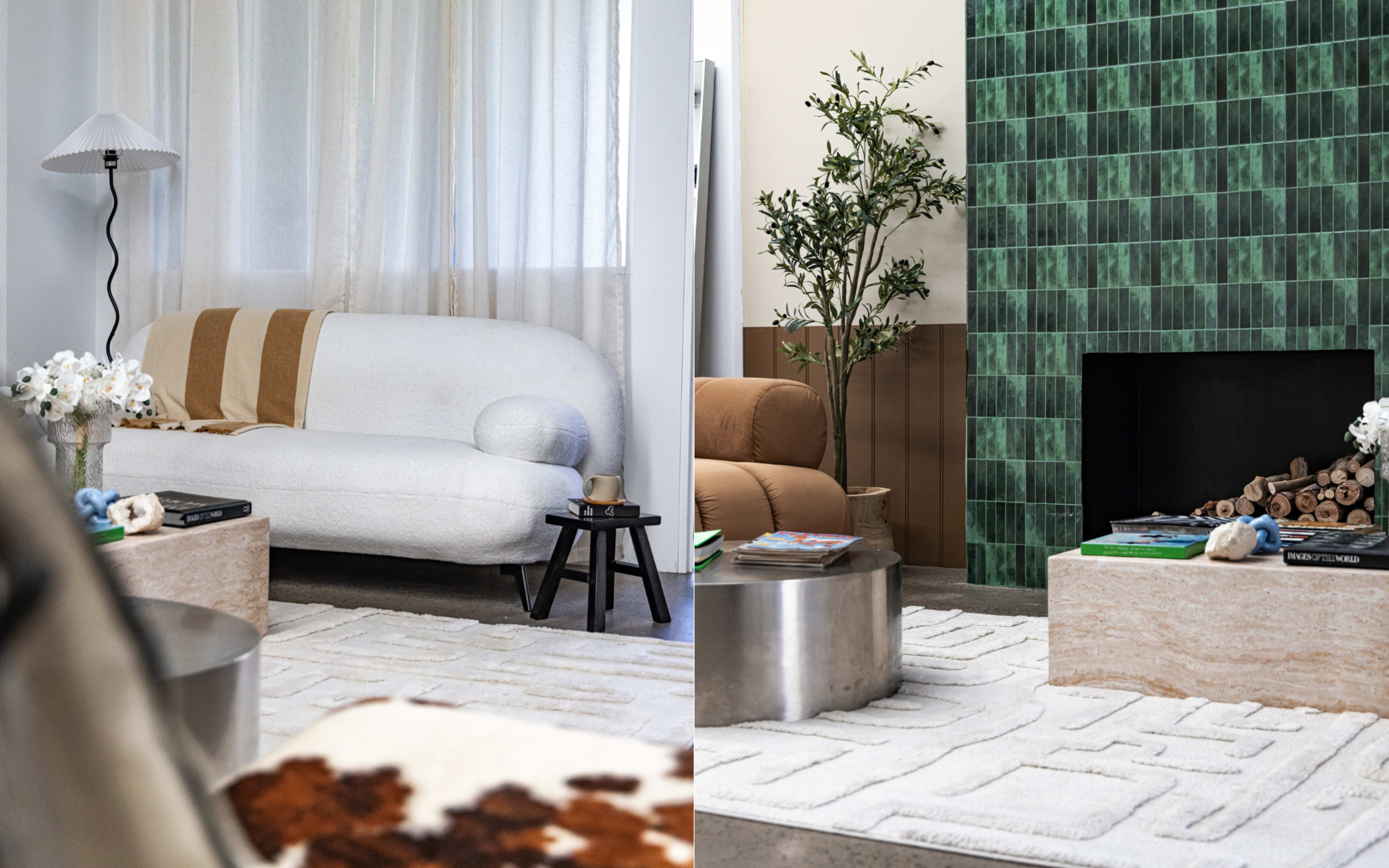 The image shows a modern living room divided into two sections, featuring a white plush sofa, a black side table, and a green tiled wall with a fireplace on one side, while the other side displays a tan sofa and a patterned rug.