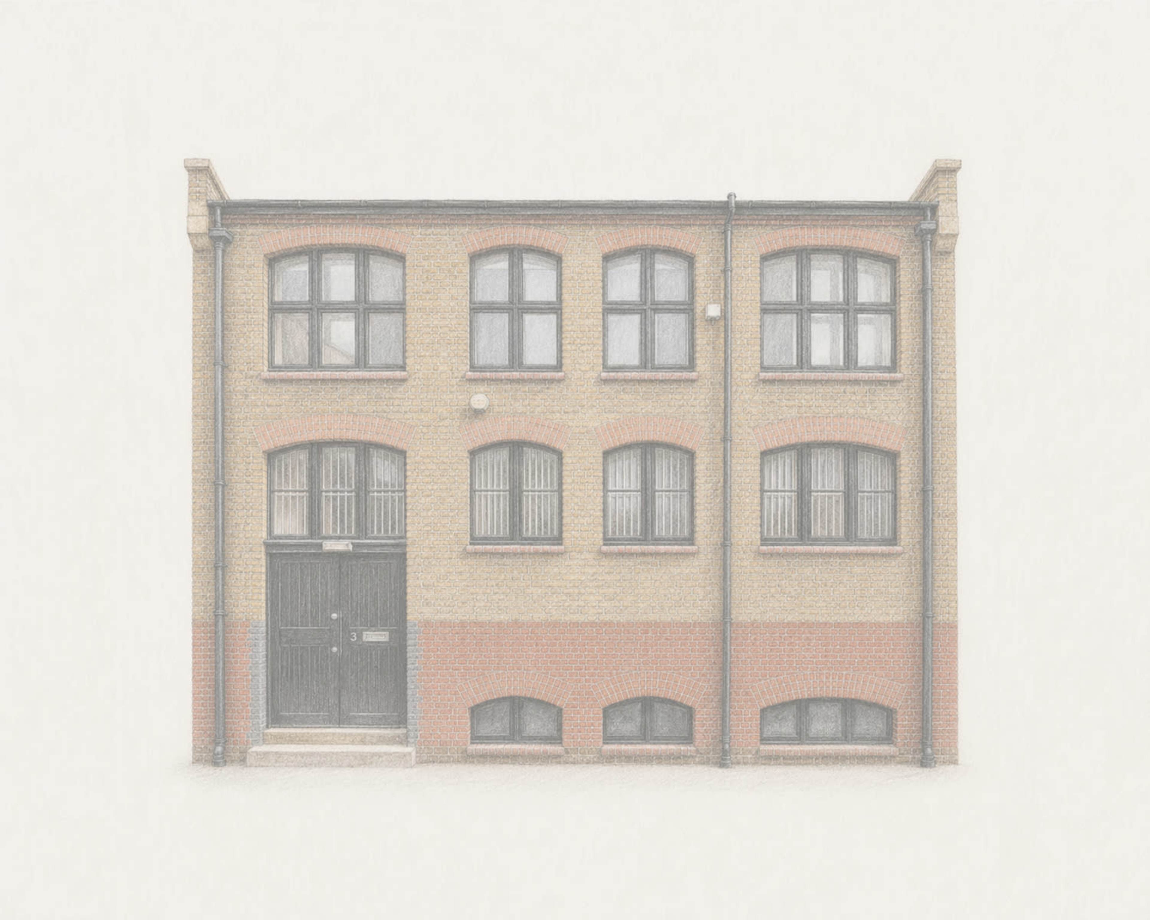 The image shows a two-story brick building with multiple windows and a central entrance door.
