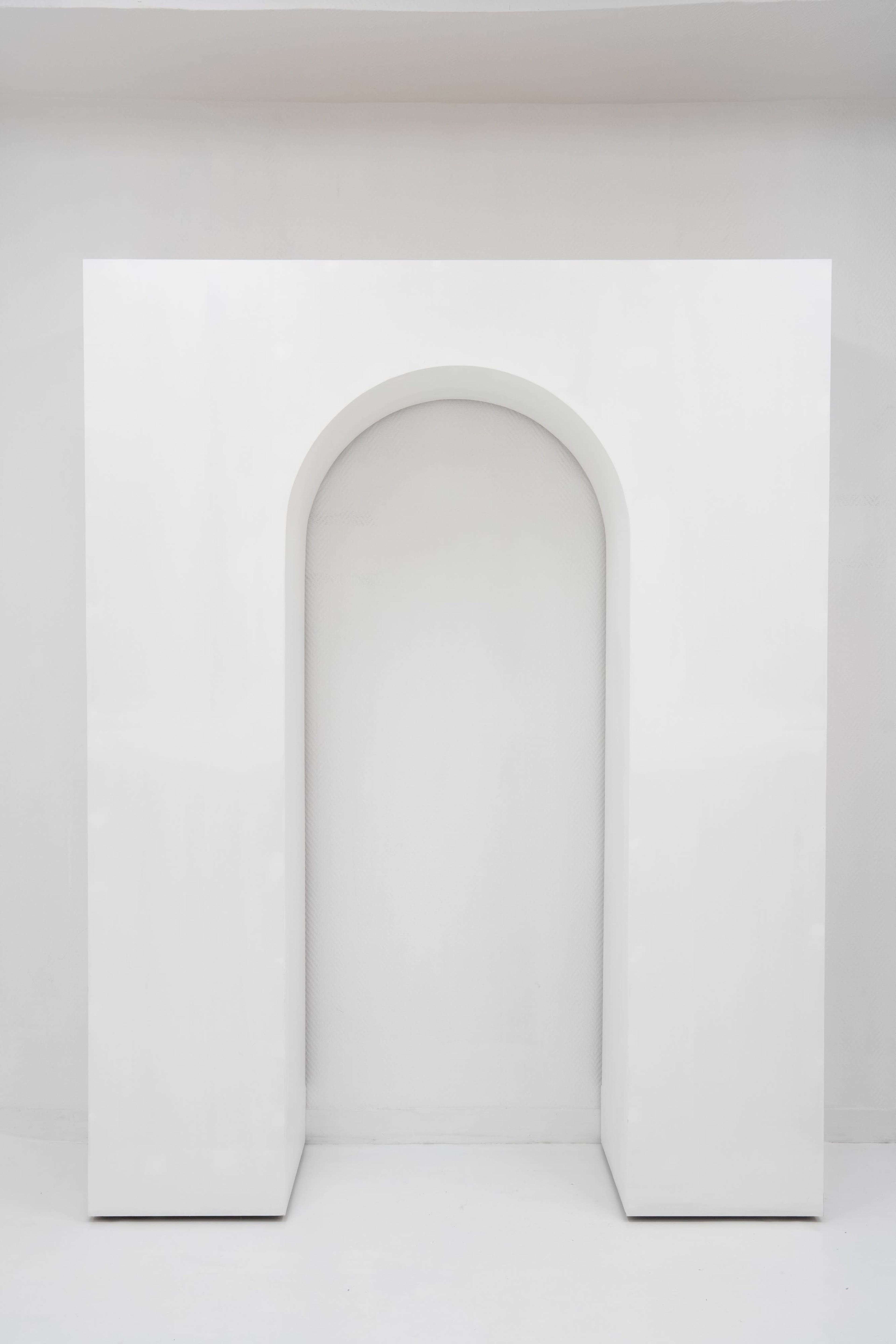 The image features a minimalist white archway set against a plain white background.