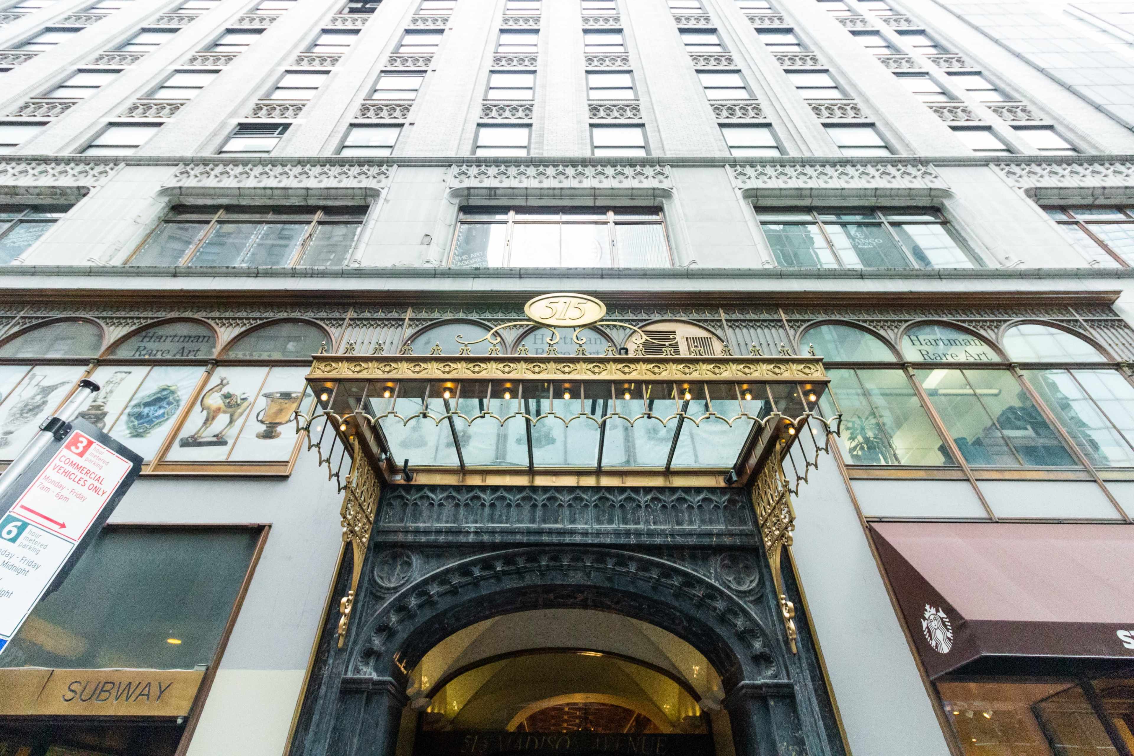 The image shows the entrance of a historic building with ornate architectural details and the address "515" prominently displayed.