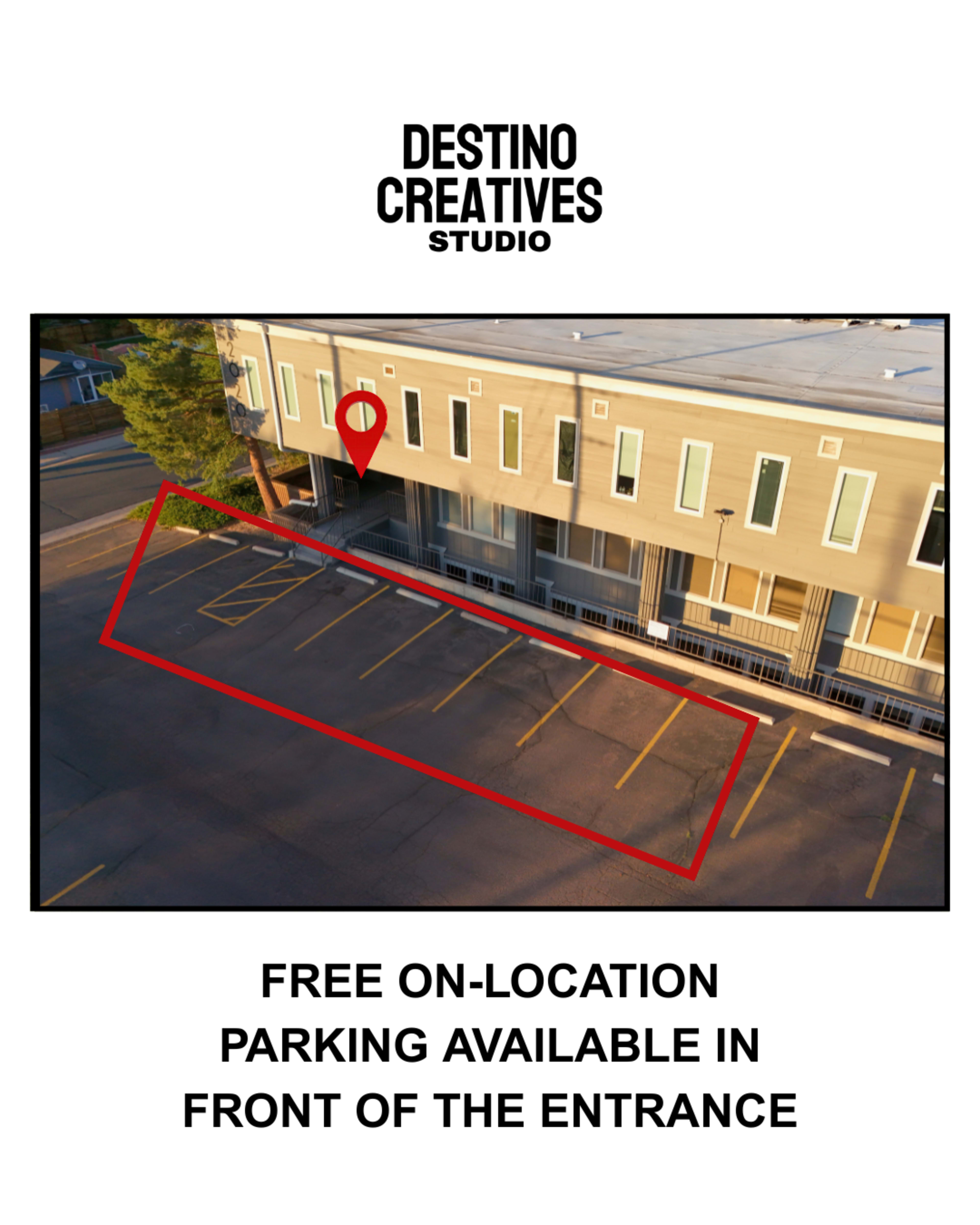 The image shows a parking area marked in red with a sign indicating free on-location parking available in front of a building entrance.