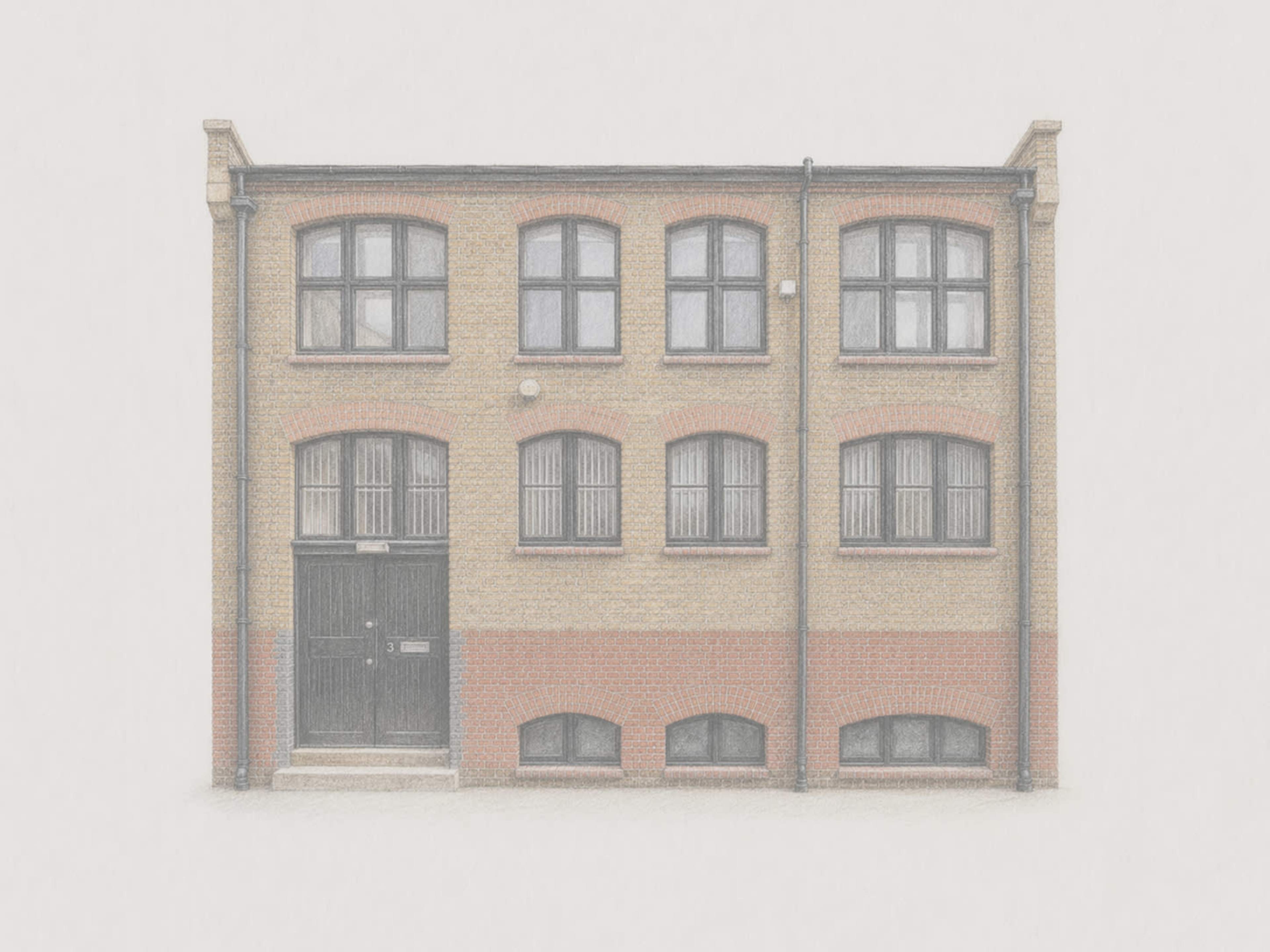 The image depicts a two-story brick building with multiple windows and a central entrance door.