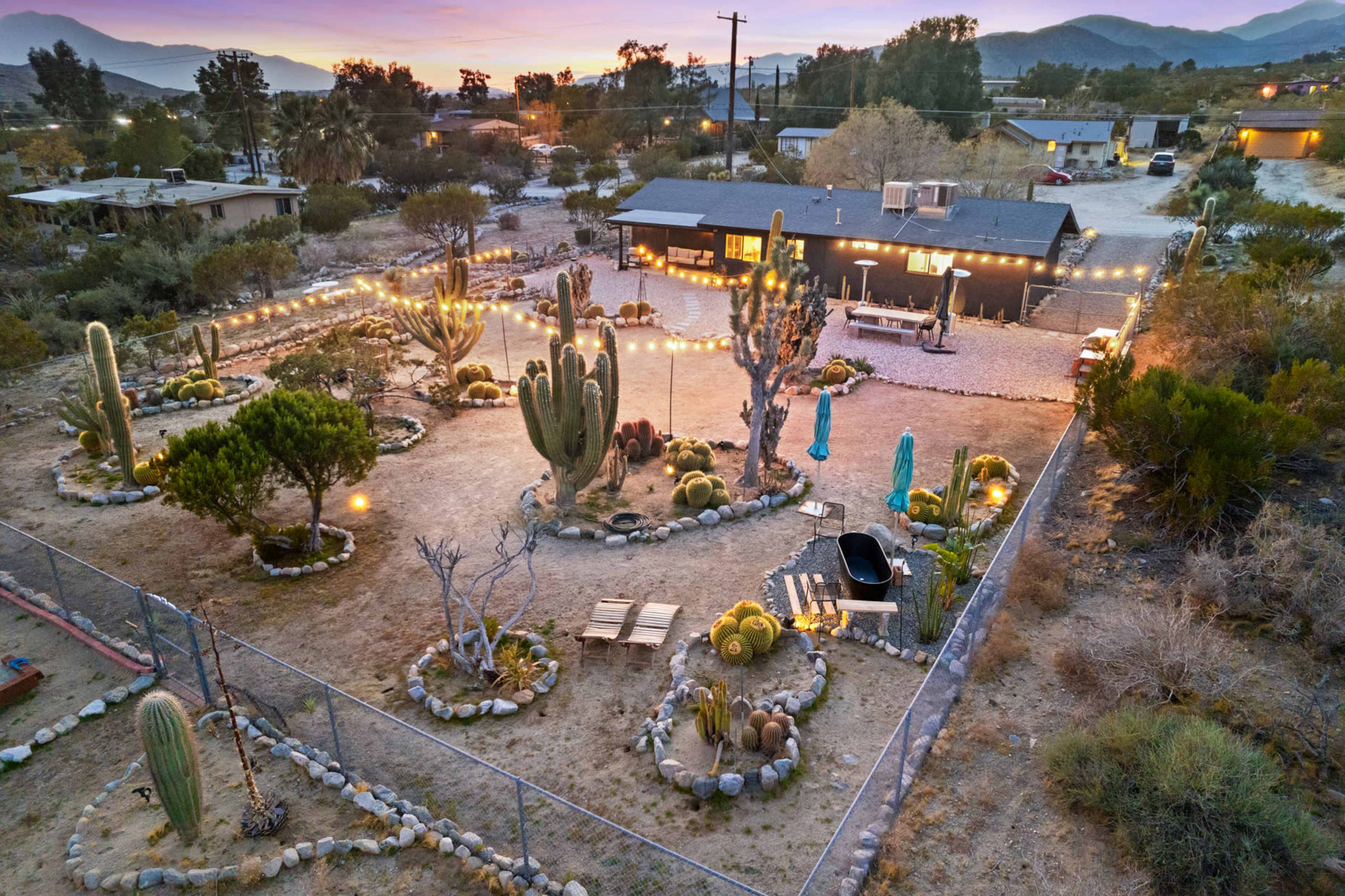 A desert home sitting in a cactus-filled botanical garden Image in , MORONGO VALLEY, CA
