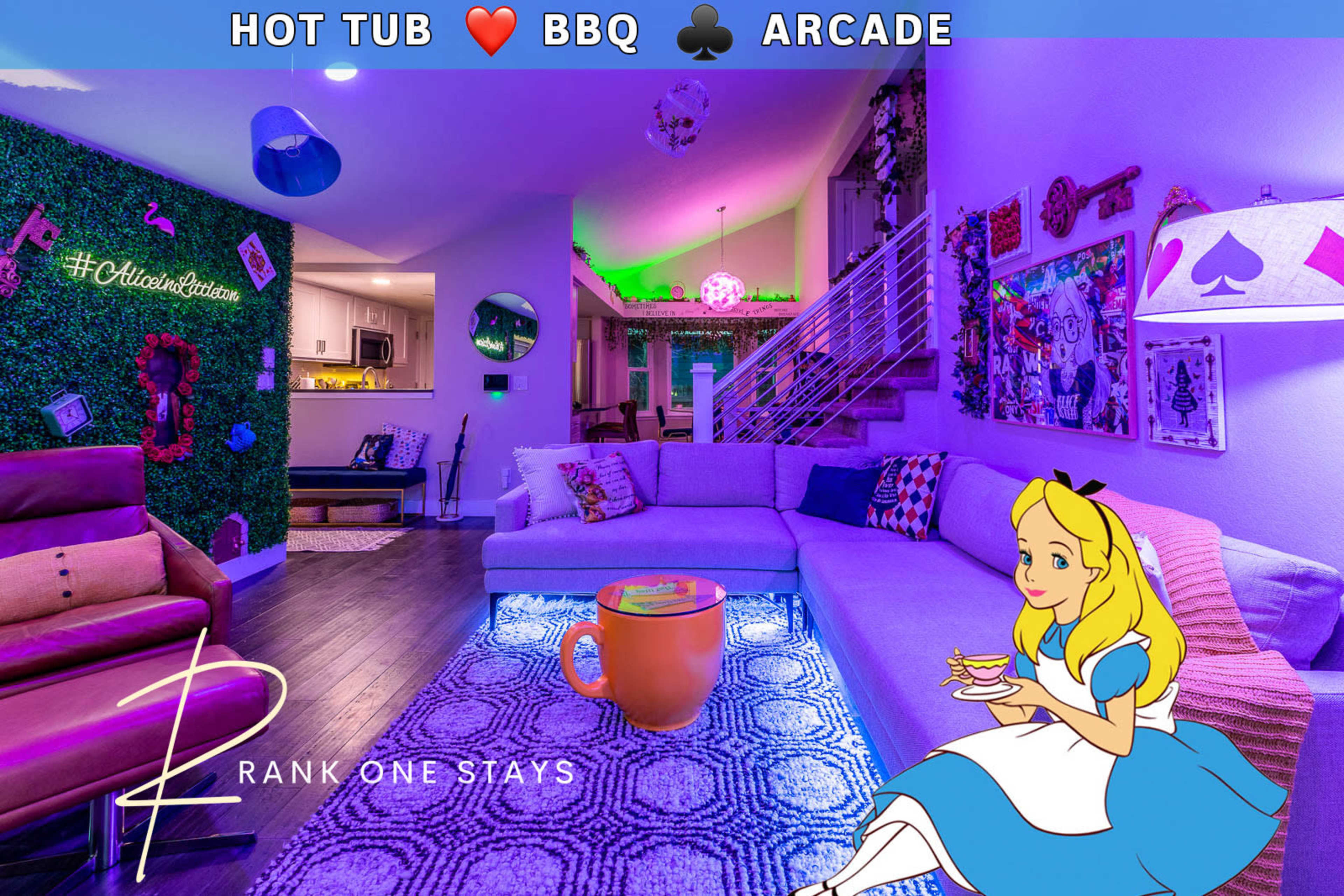 The image depicts a colorful lounge area featuring a large purple sofa, illuminated by ambient lights, with playful decorations and a sign indicating amenities like a hot tub, BBQ, and arcade.