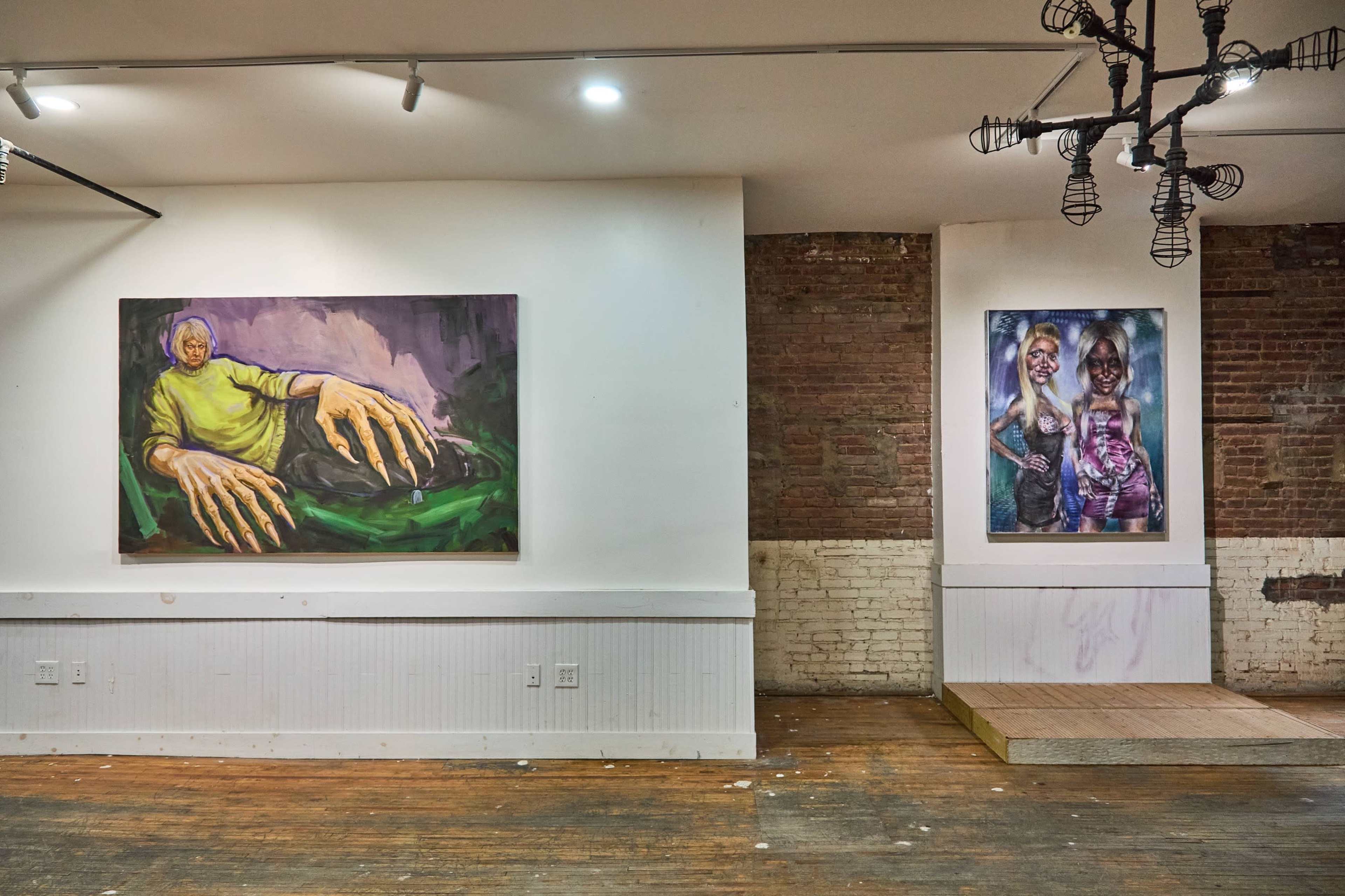 The image shows an art gallery with two large paintings on the walls, one depicting a figure with exaggerated hands and the other featuring two women in vibrant clothing.