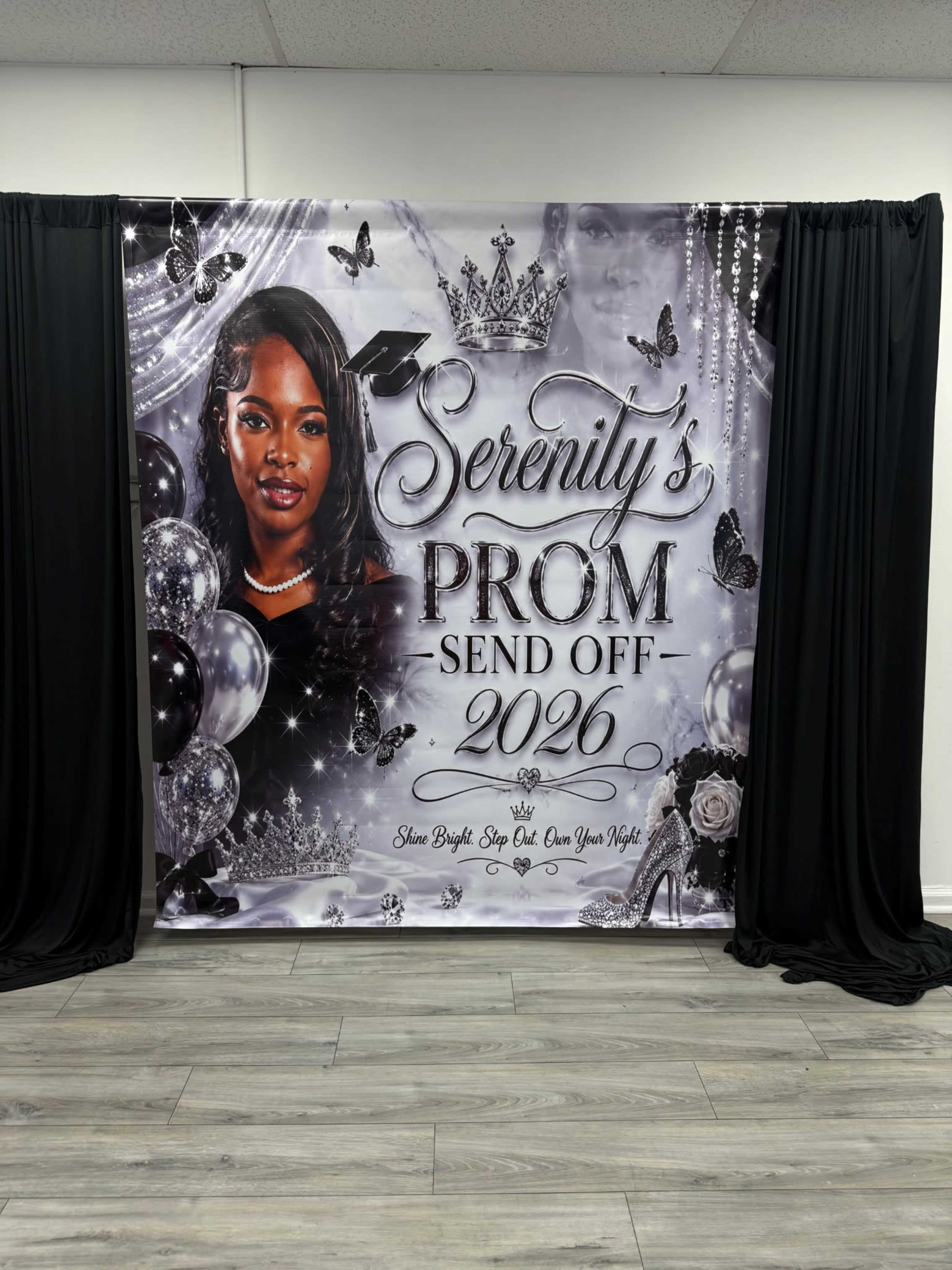 The image features a large decorative backdrop for a prom send-off event, displaying the name "Serenity," the year "2026," and various embellishments like crowns and butterflies.