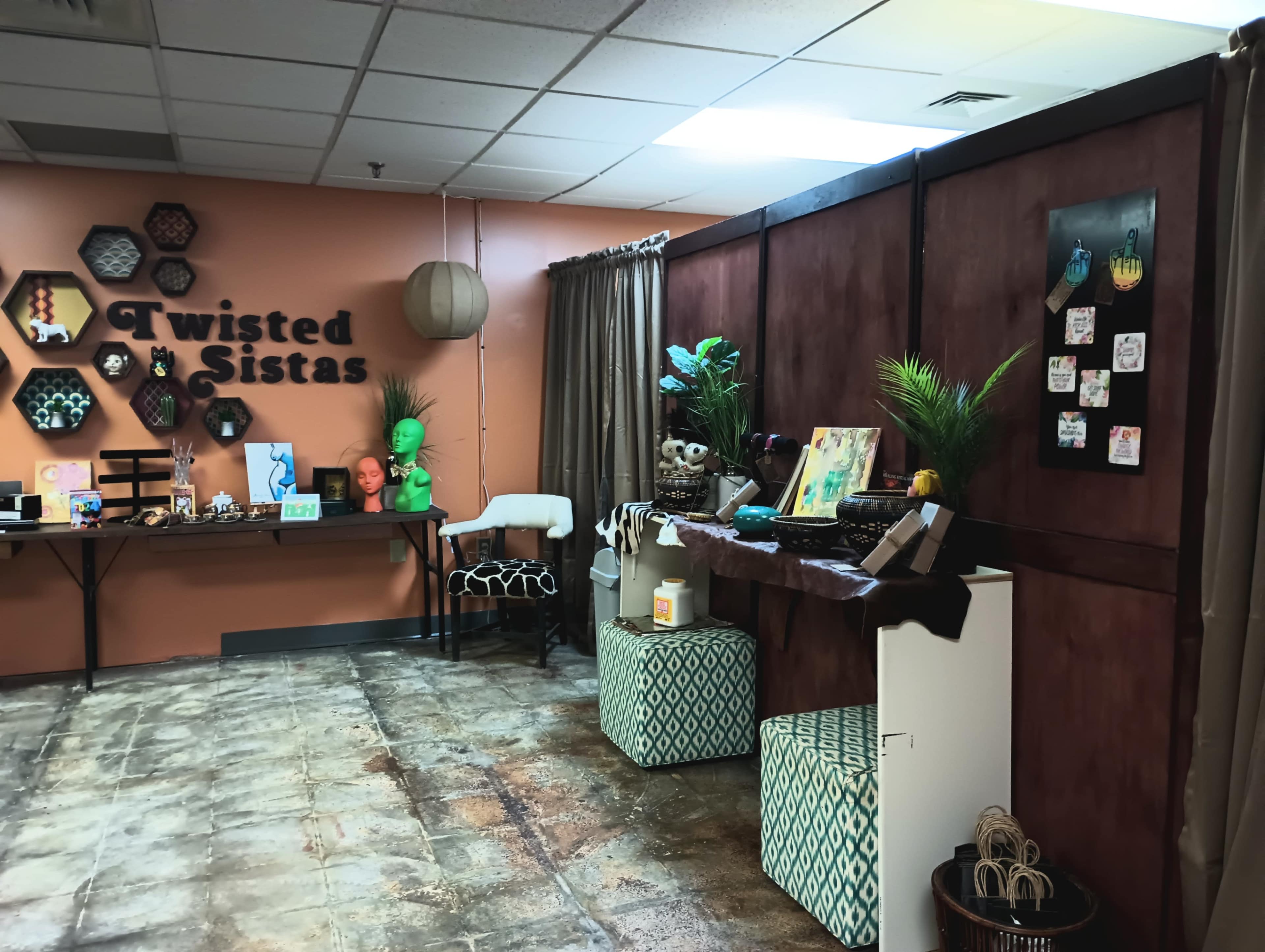 The image shows an interior space labeled "Twisted Sistas," featuring decorative elements, including art pieces, plants, and various furnishings along the walls.