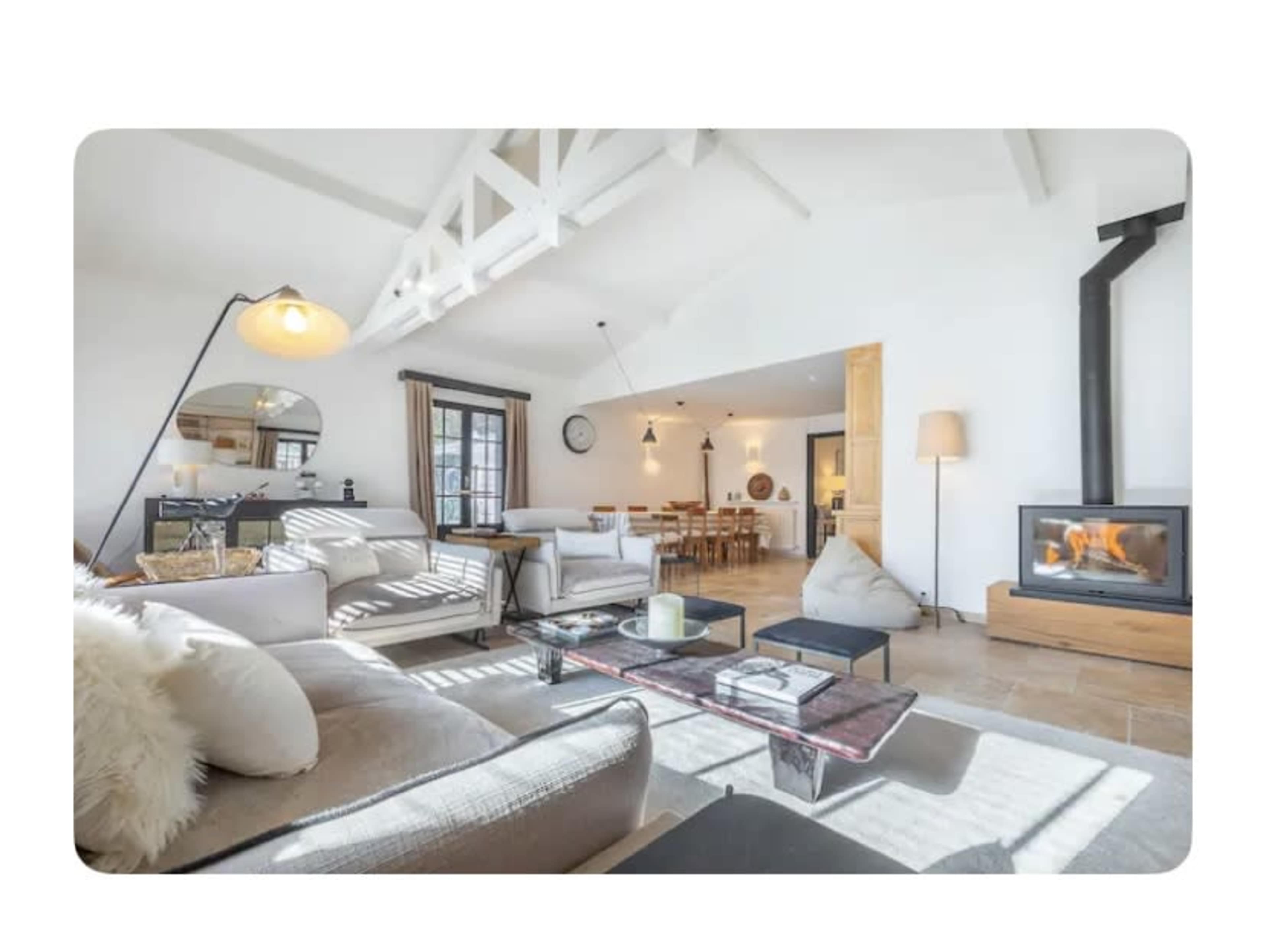 A spacious living room features a comfortable seating area with a fireplace and an adjacent dining space.