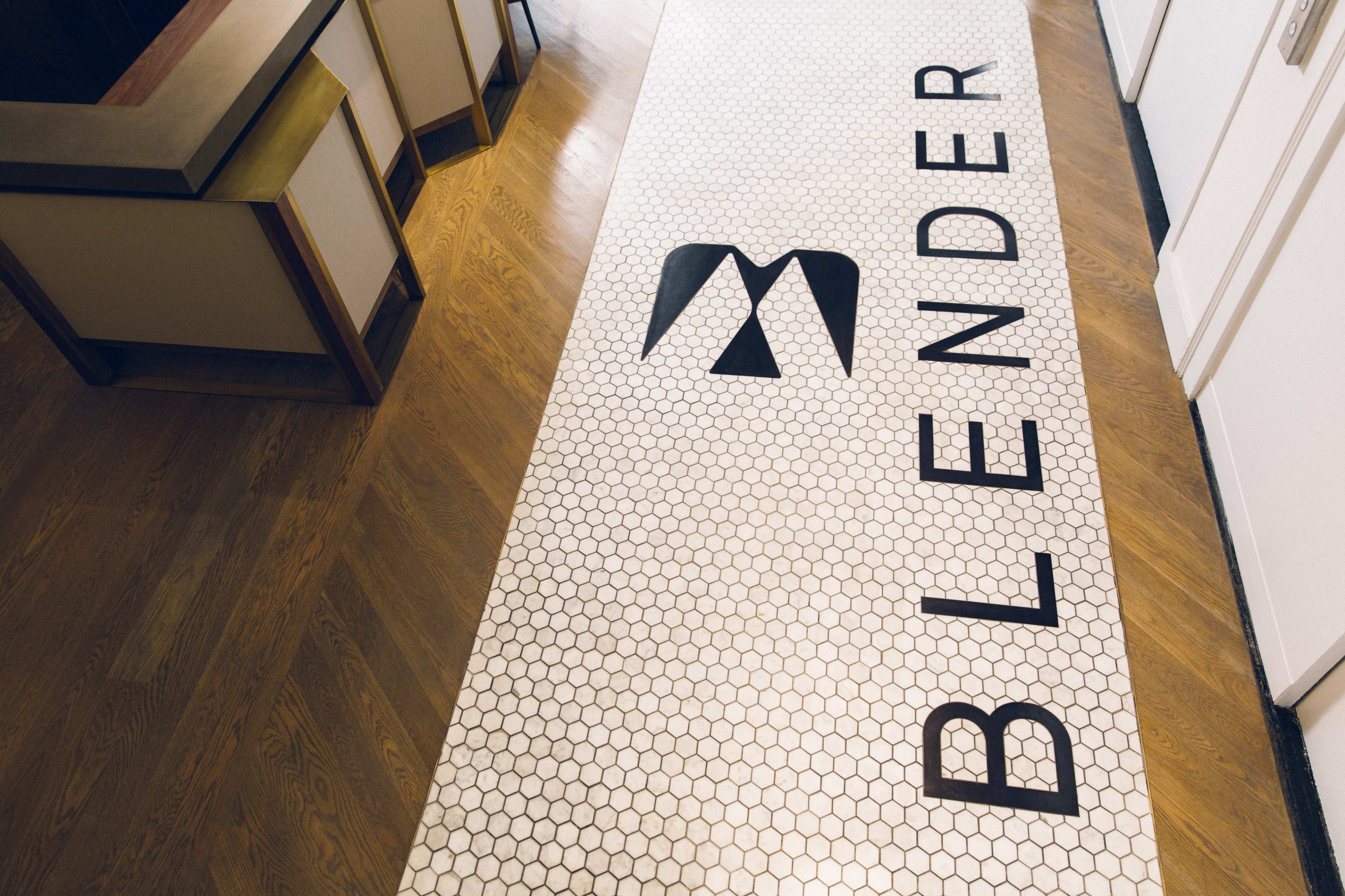 A tiled floor with the word "BLENDER" prominently displayed in large letters.