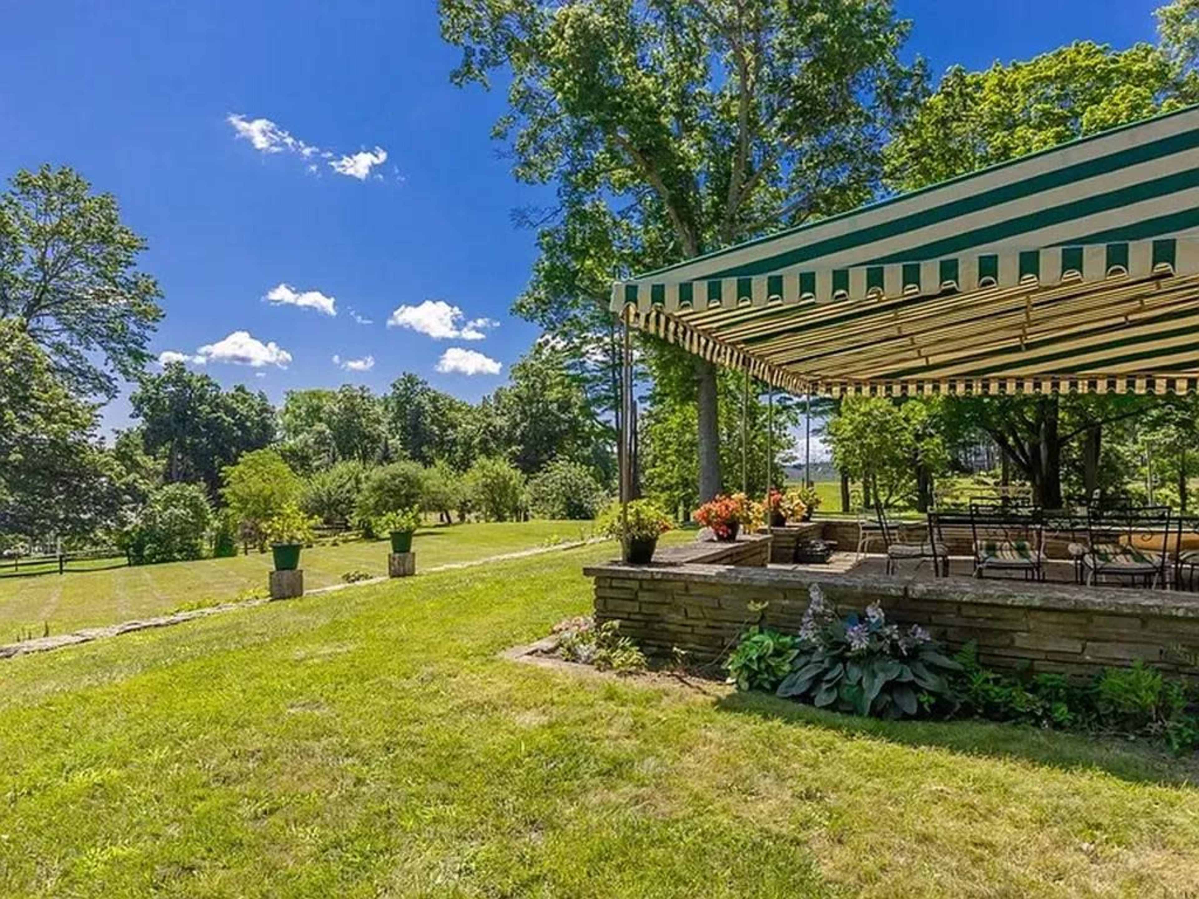 Tranquil antique farmhouse with horses grazing in the pastures. Image in Ipswich, Ipswich, MA