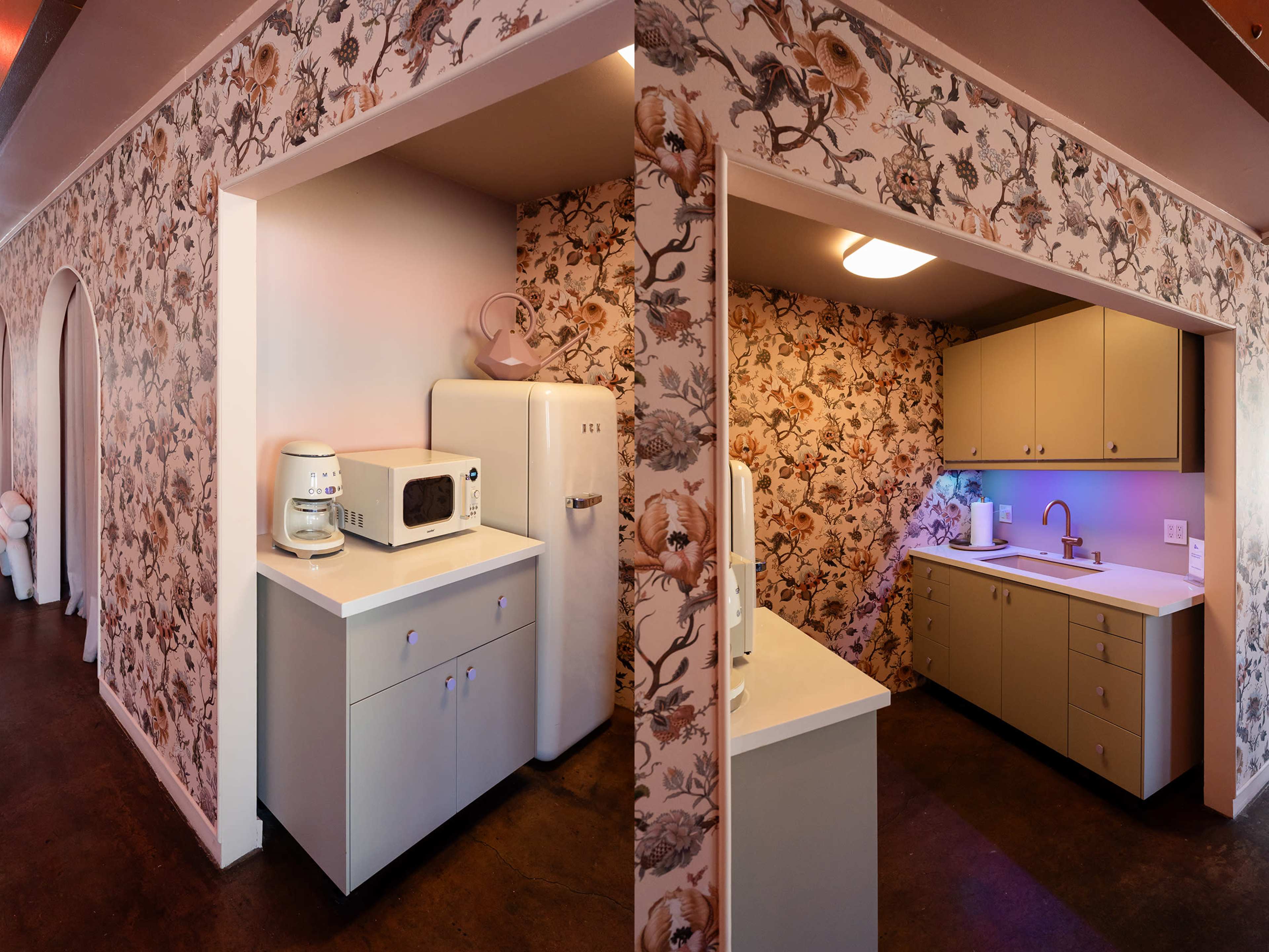 The image shows a small kitchen area with a floral wallpaper, featuring a white microwave and refrigerator, alongside beige cabinets and a sink.