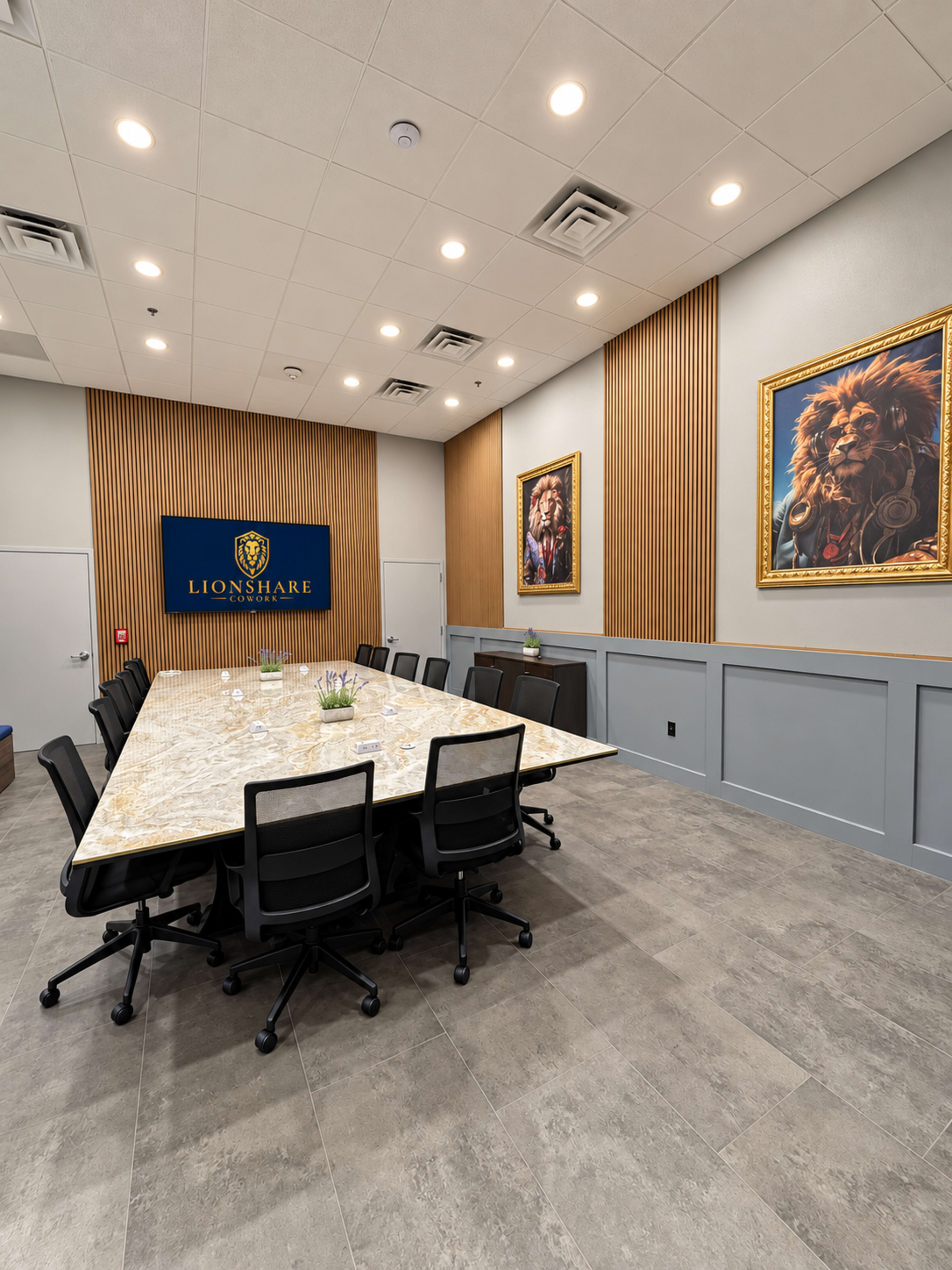 The image shows a modern conference room with a large, elongated table surrounded by black office chairs, adorned with two lion portraits on the walls and a branded sign that reads "LIONSHARE."