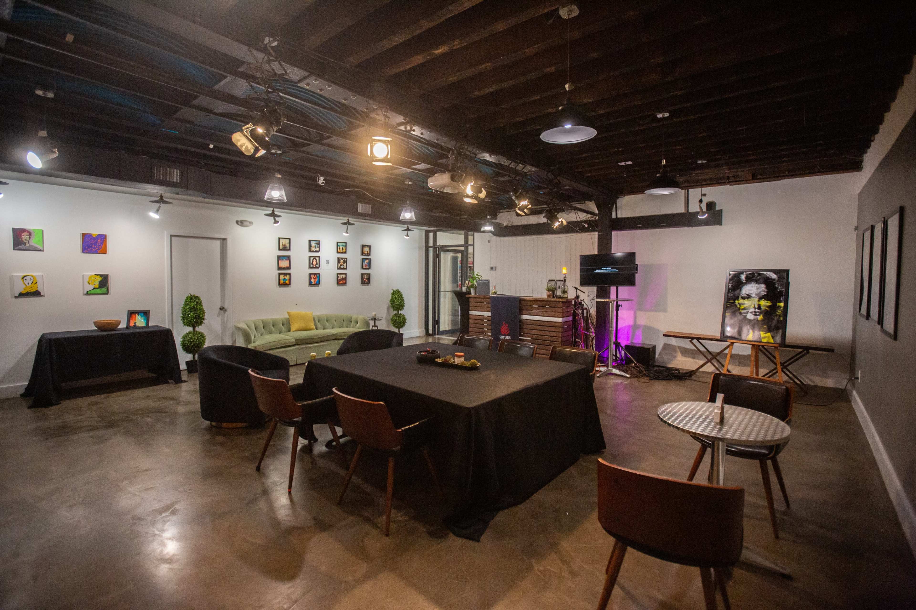 A spacious, modern interior with various seating arrangements, artwork on the walls, and a clean, polished floor.