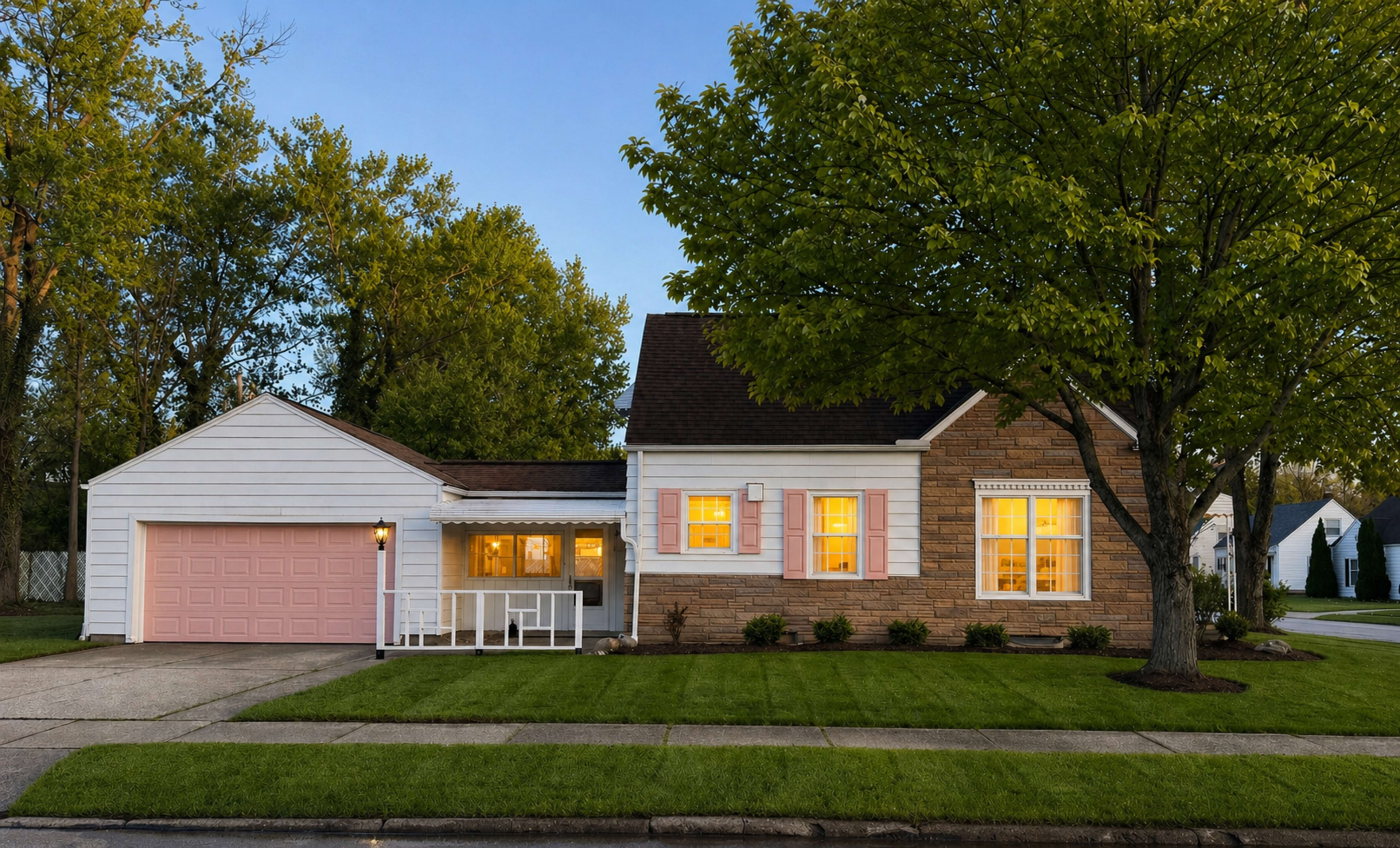 A single-story house with a blend of stone and siding features a pink garage door and well-maintained landscaping in front.
