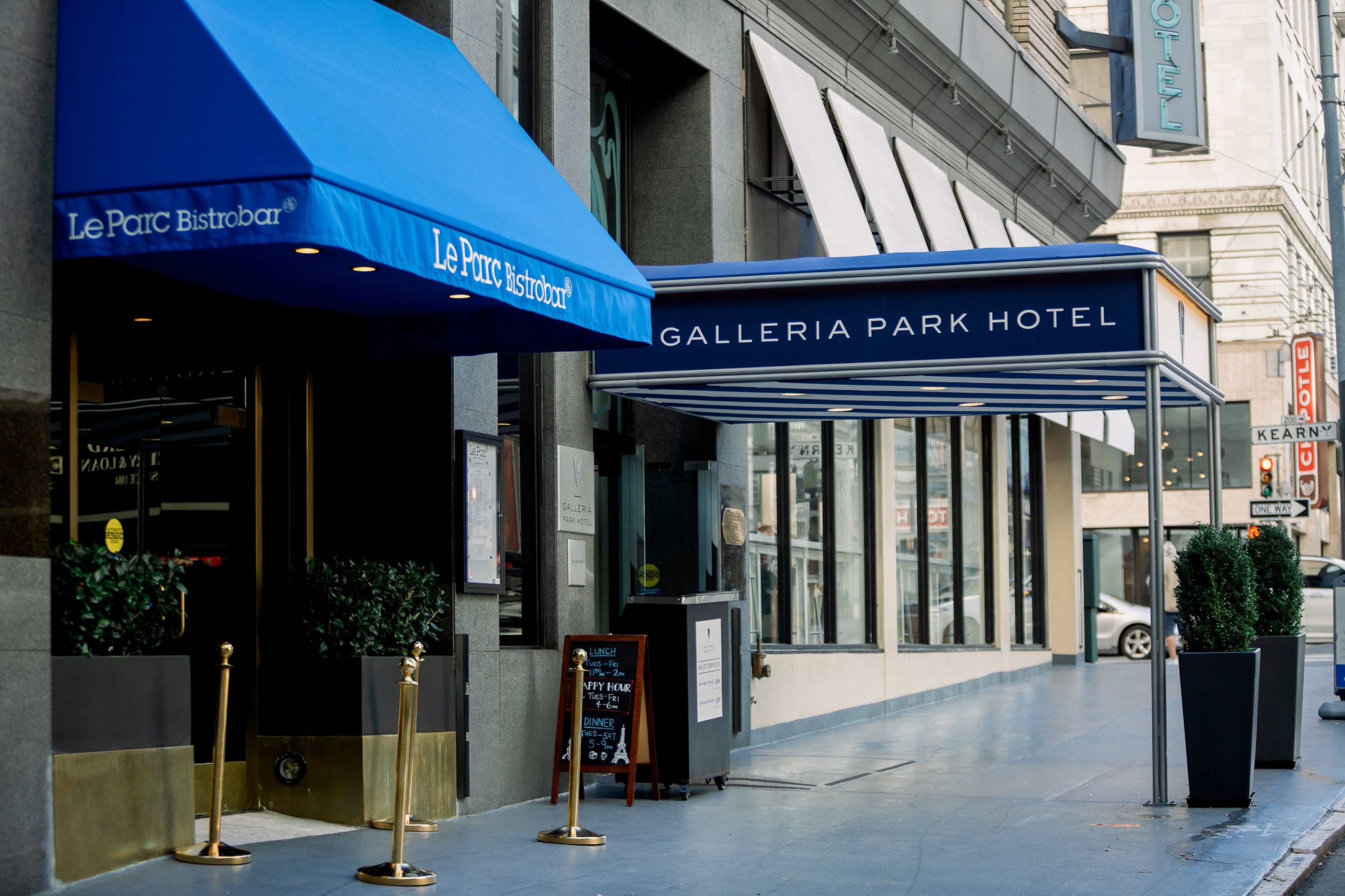 The image shows the entrances of Le Parc Bistro and Galleria Park Hotel, both featuring blue awnings, on a city street.
