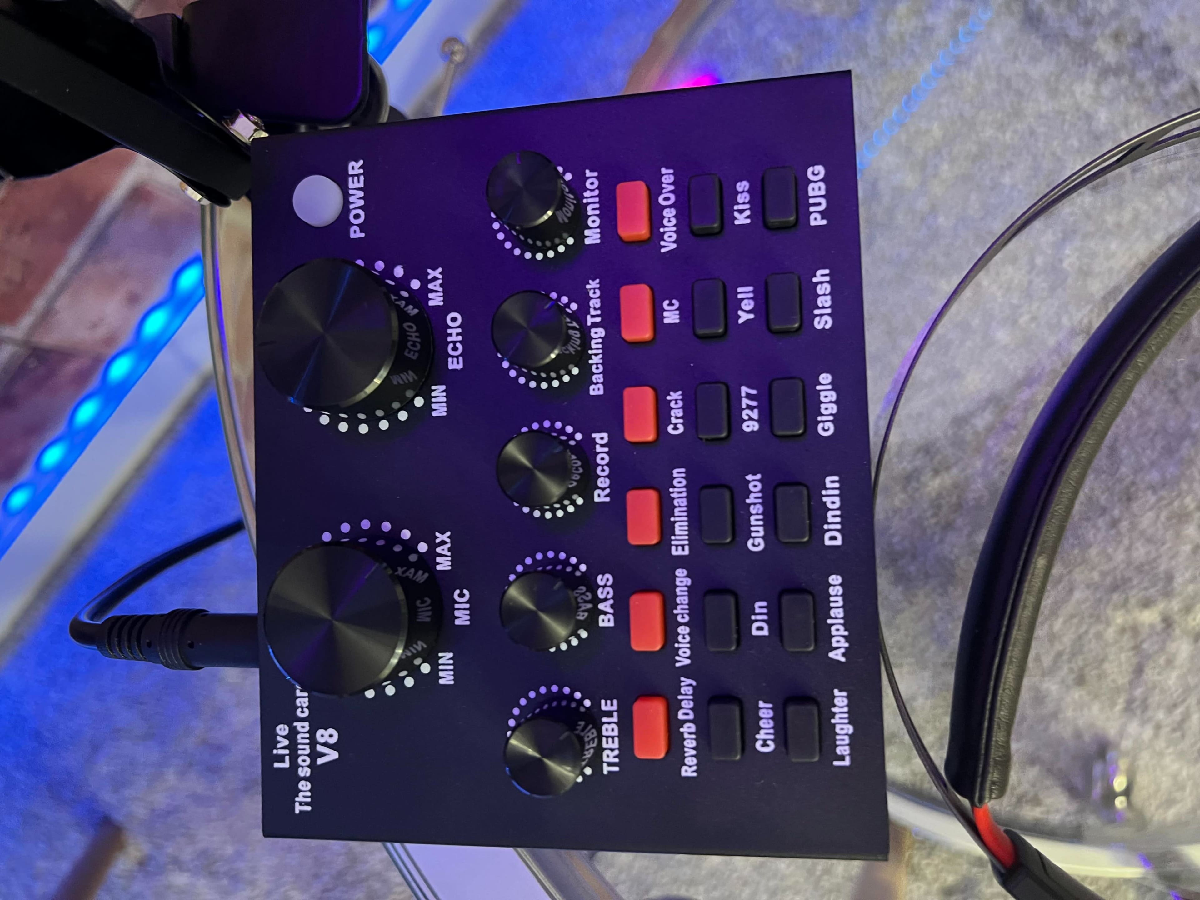 The image shows a audio mixer control panel featuring knobs for power, echo, monitor, volume, bass, treble, and several audio effects.