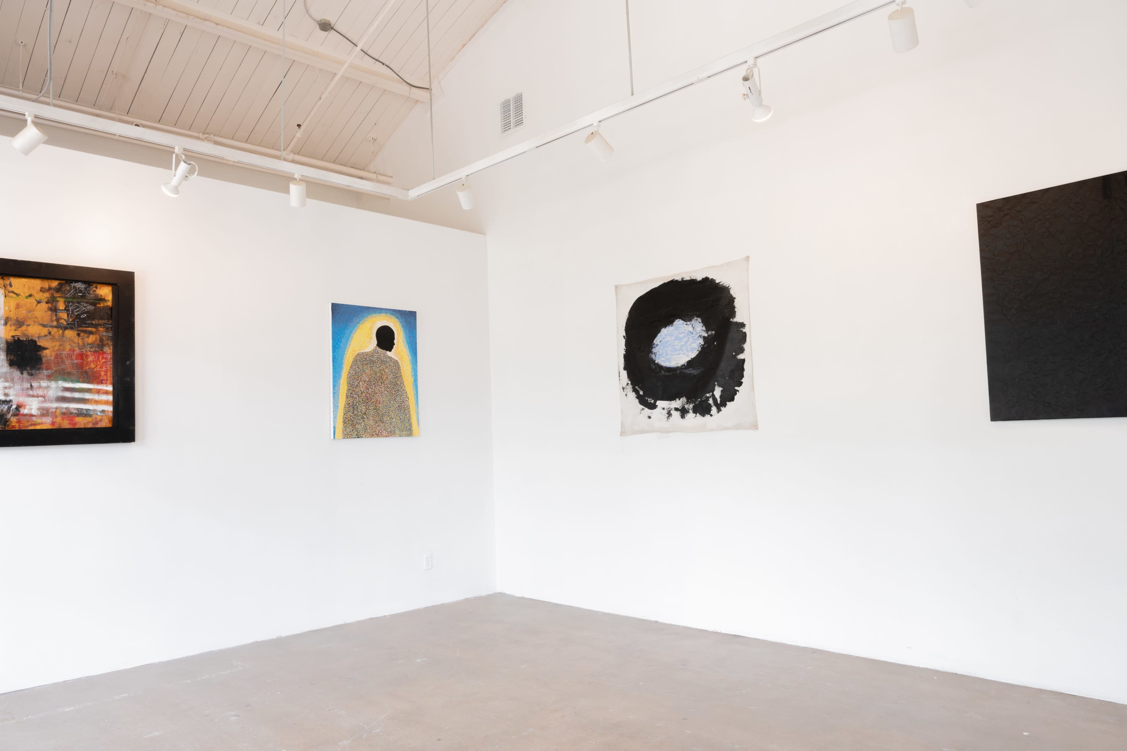 The image shows an art gallery with four paintings displayed on the white walls, featuring various abstract designs.