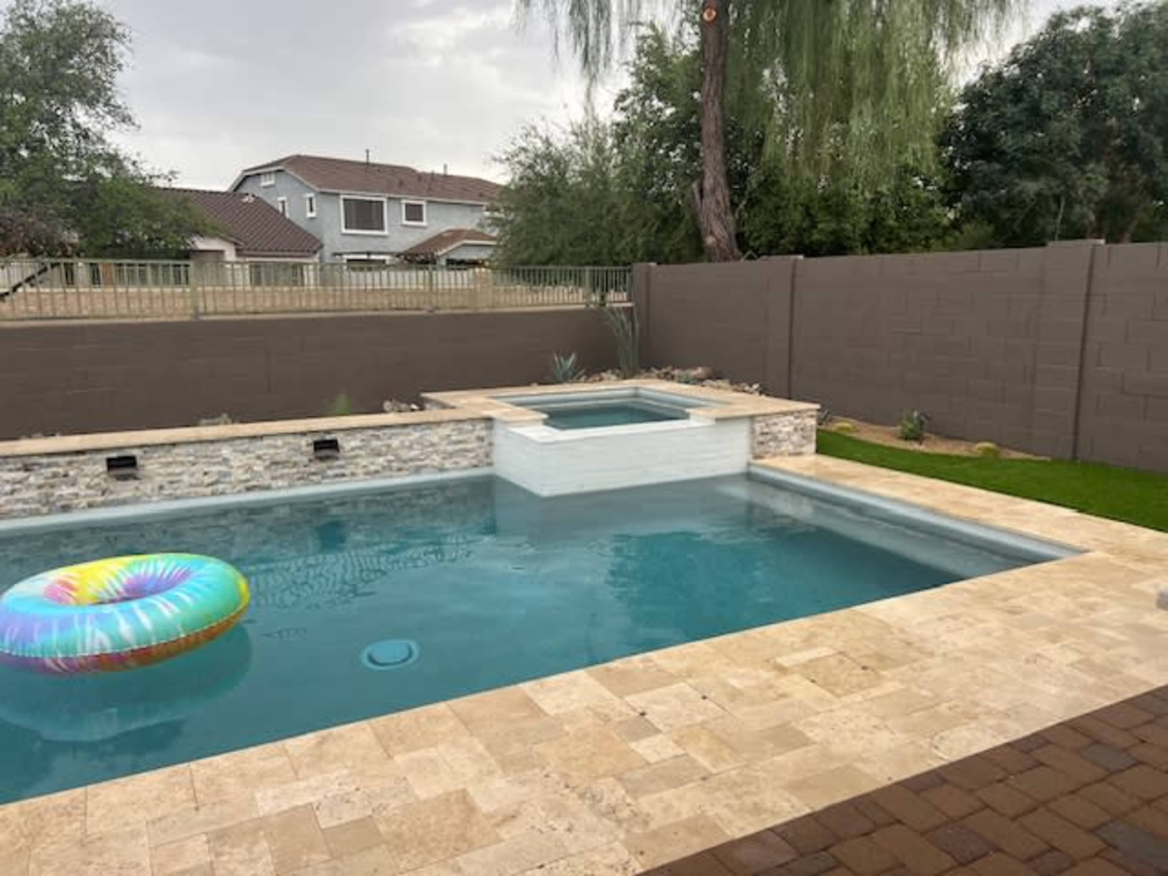 Newly renovated backyard with heated pool/spa, BBQ area and fire pit. Image in Emperor Estates, Queen Creek, AZ