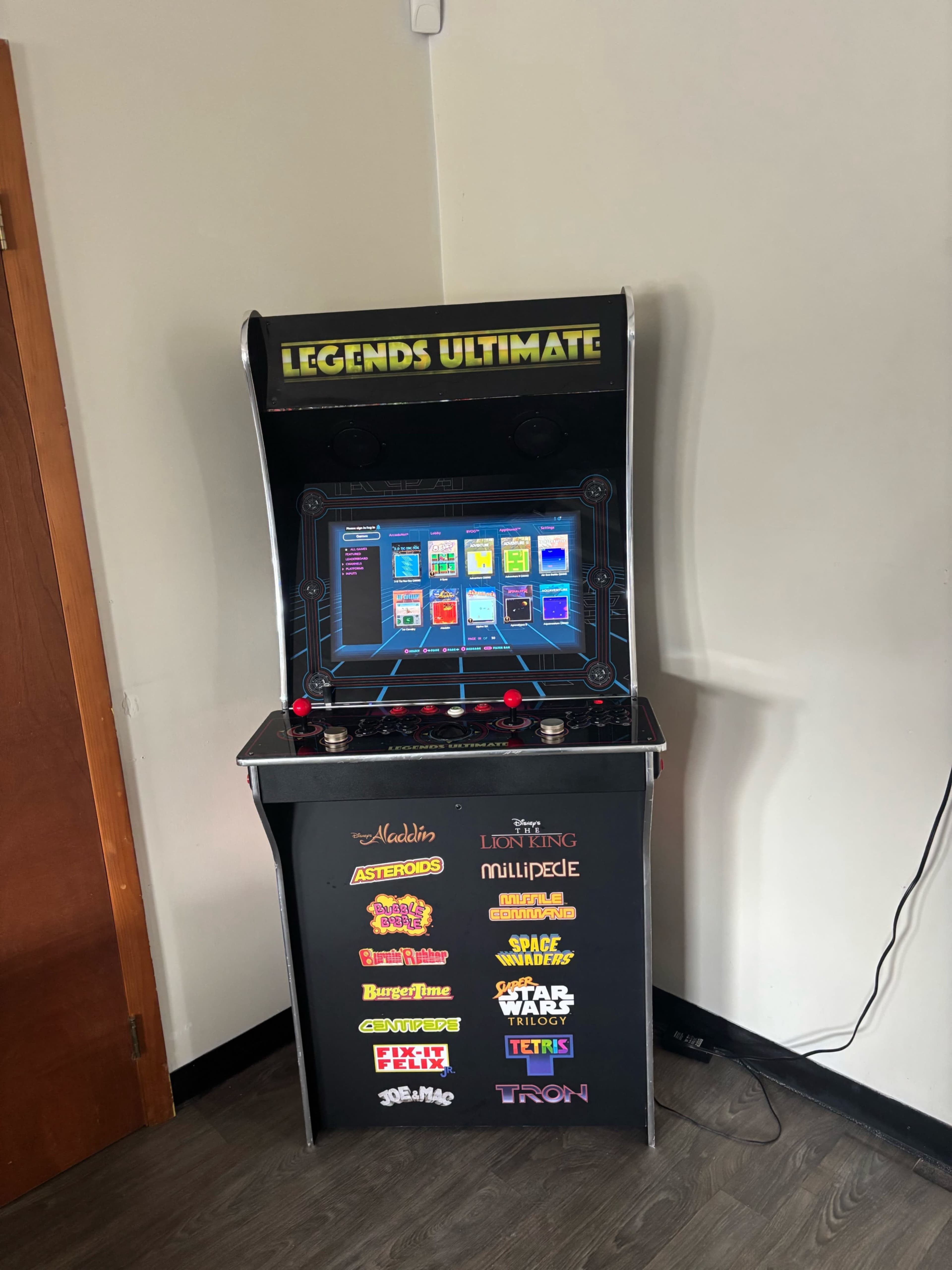The image shows a Legends Ultimate arcade gaming cabinet displaying various classic video game titles.