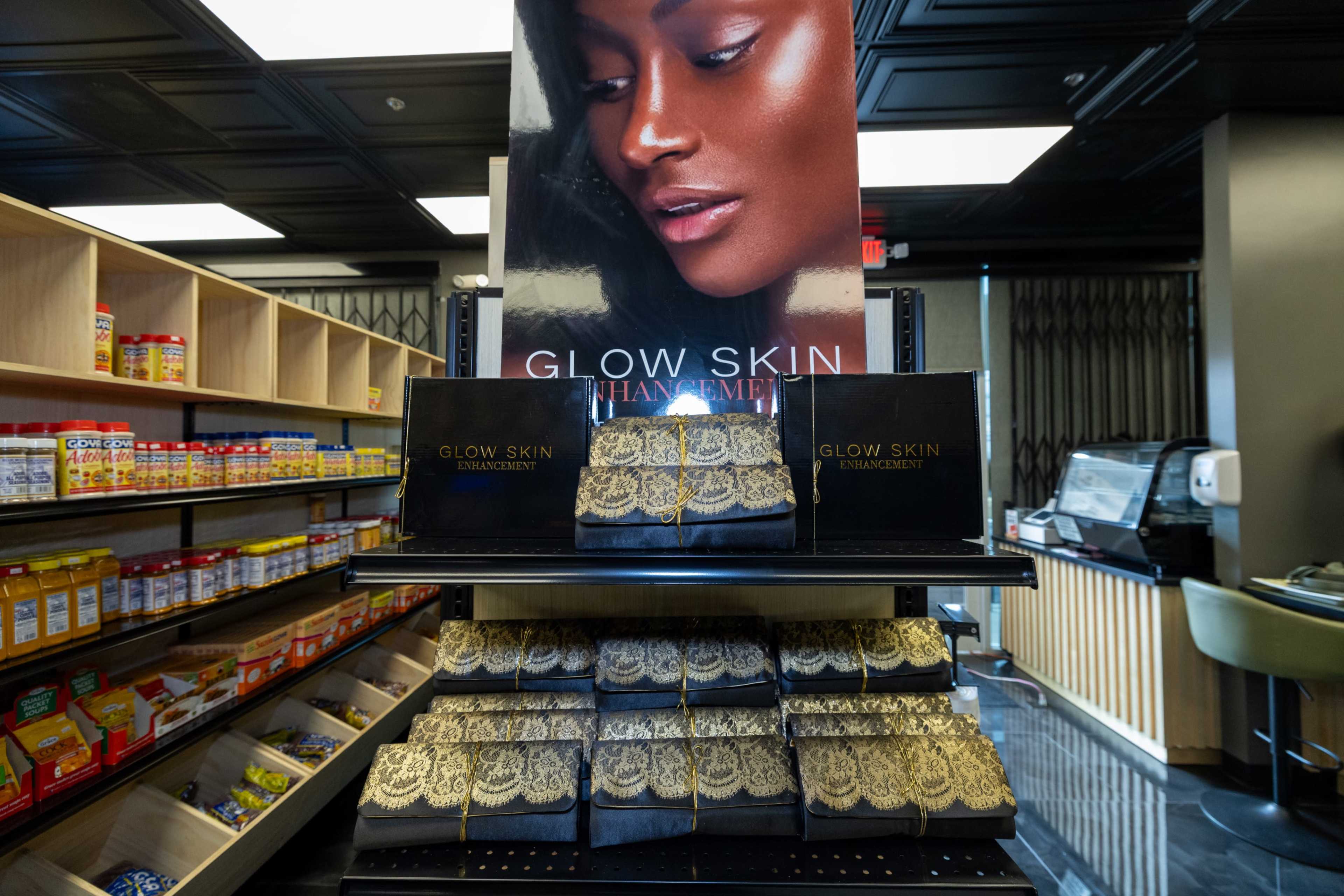 A display shelf in a store showcases GLOW SKIN enhancement products alongside a poster featuring a woman with glowing skin.