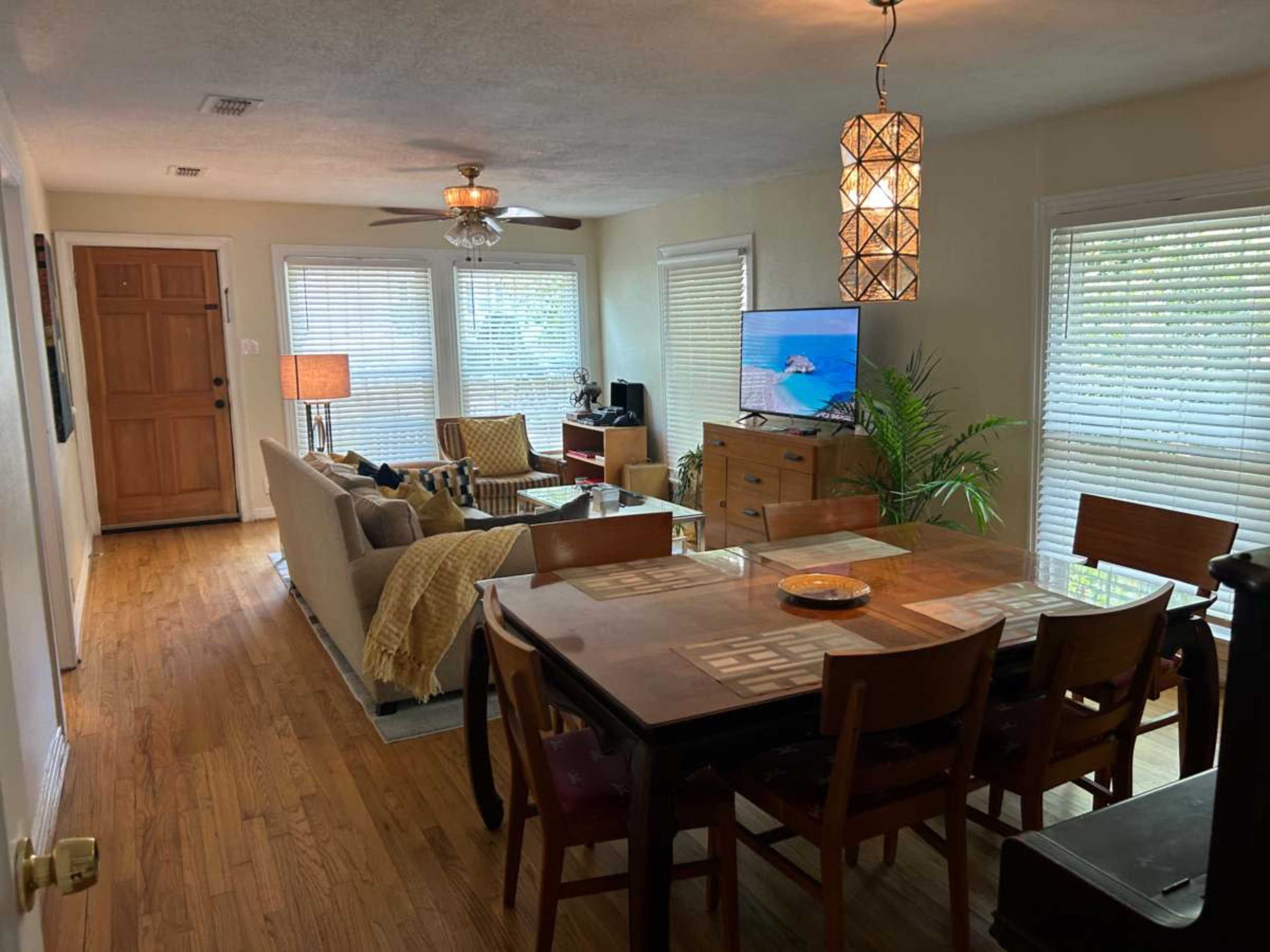 Bathed in light, modern meets historic 1940 Doctors Bungalo with covered poarch over looking  sweeping backyard and rustic cozy garden. Image in McKinney, Mckinney, TX