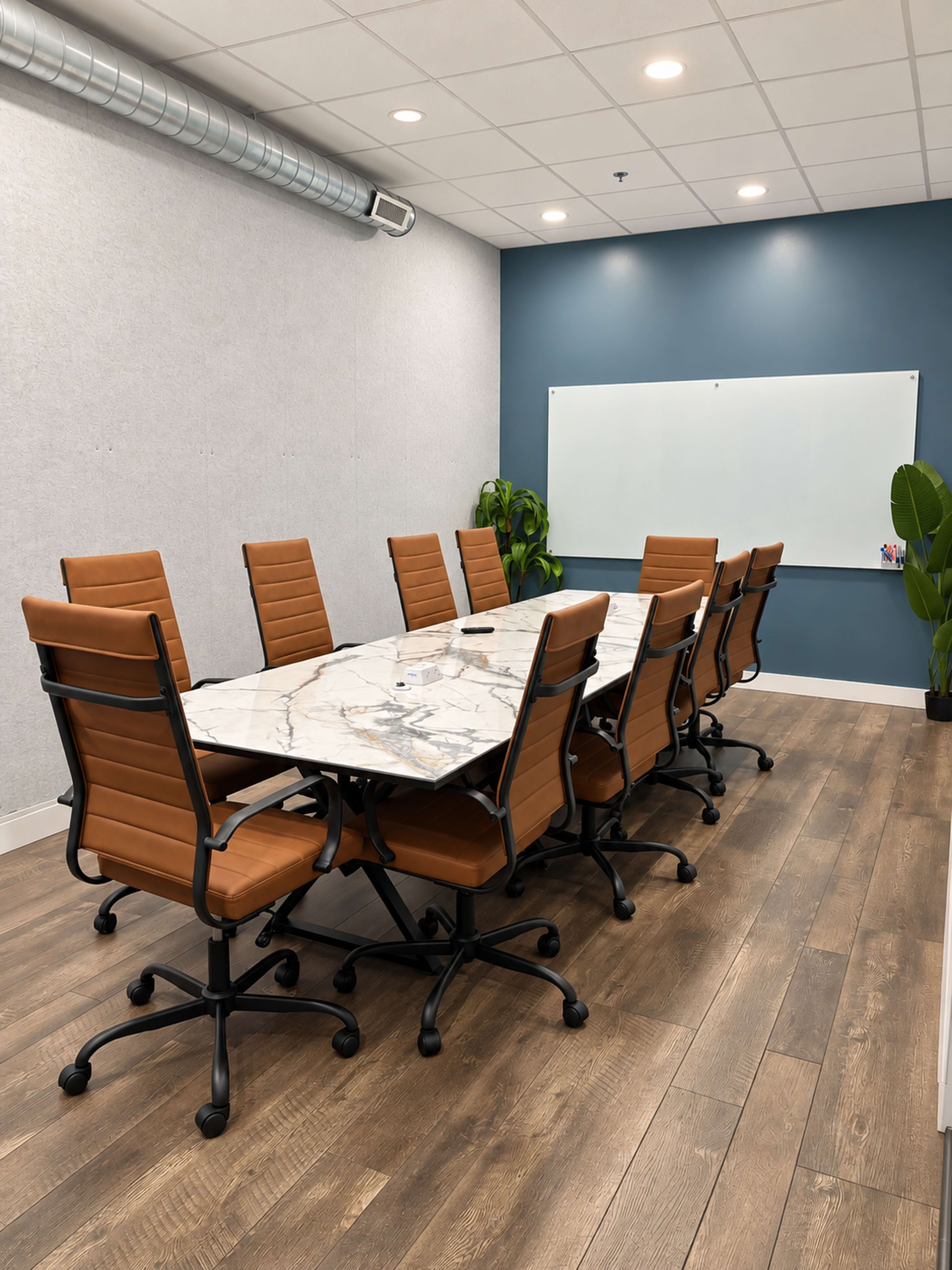 The image shows a modern conference room featuring a large marble conference table surrounded by eight brown leather office chairs, with a whiteboard and potted plant in the background.