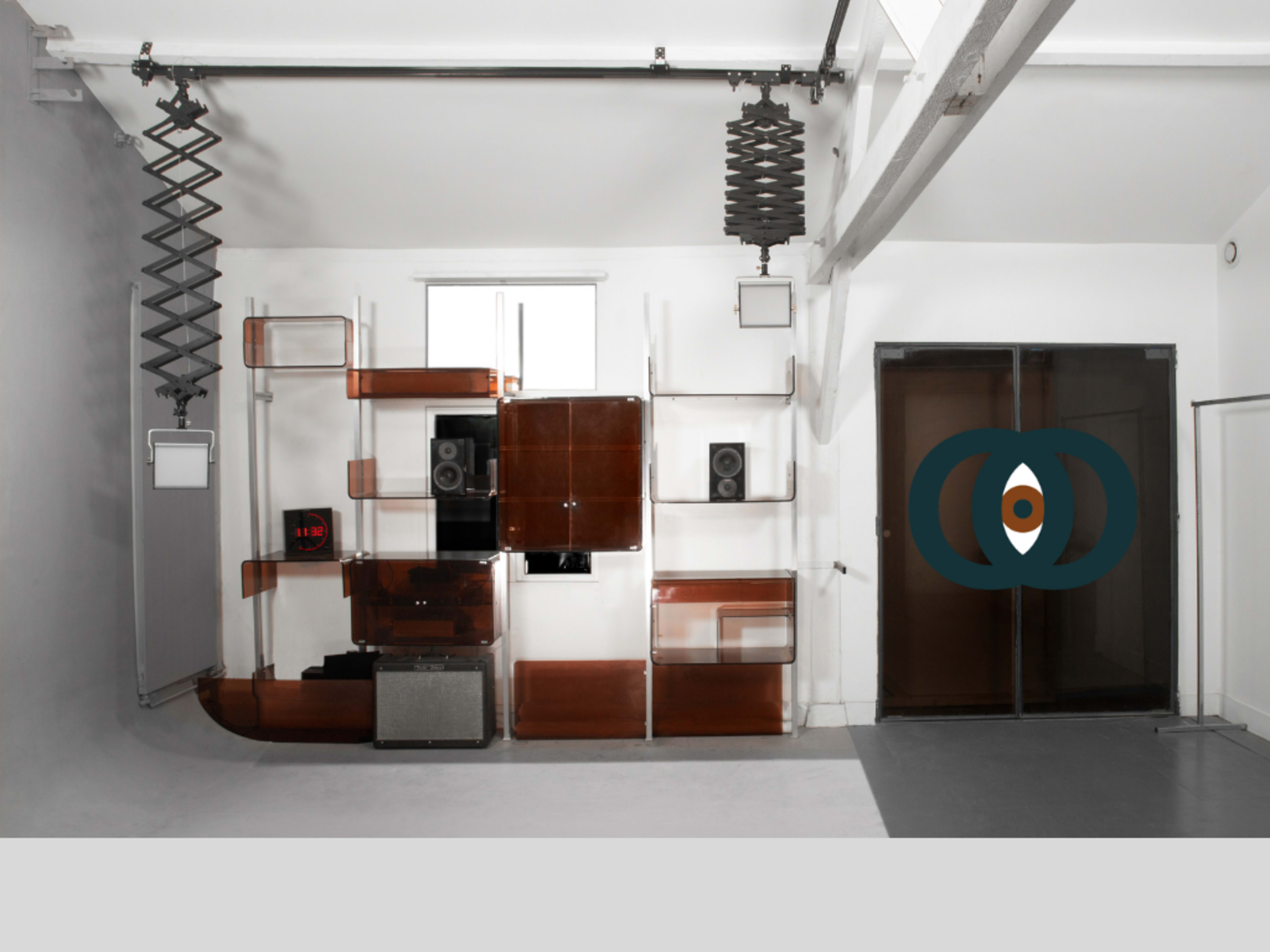 The image features a modern interior space with a sleek audio setup on a transparent shelving unit, accompanied by large glass doors.