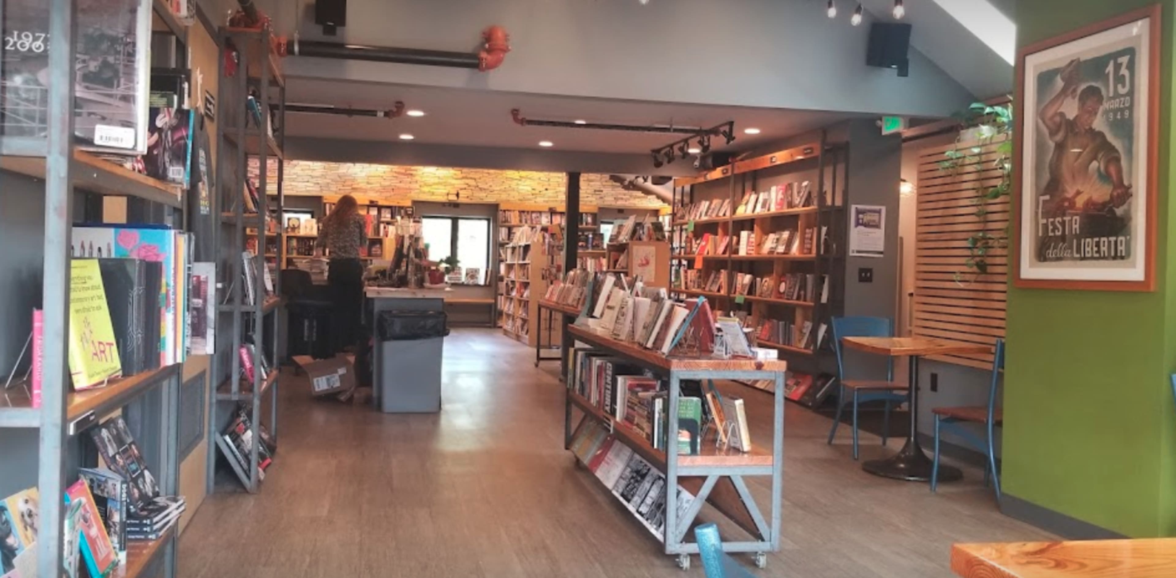 A well-organized bookstore with shelves of books lining the walls and a seating area in the center.