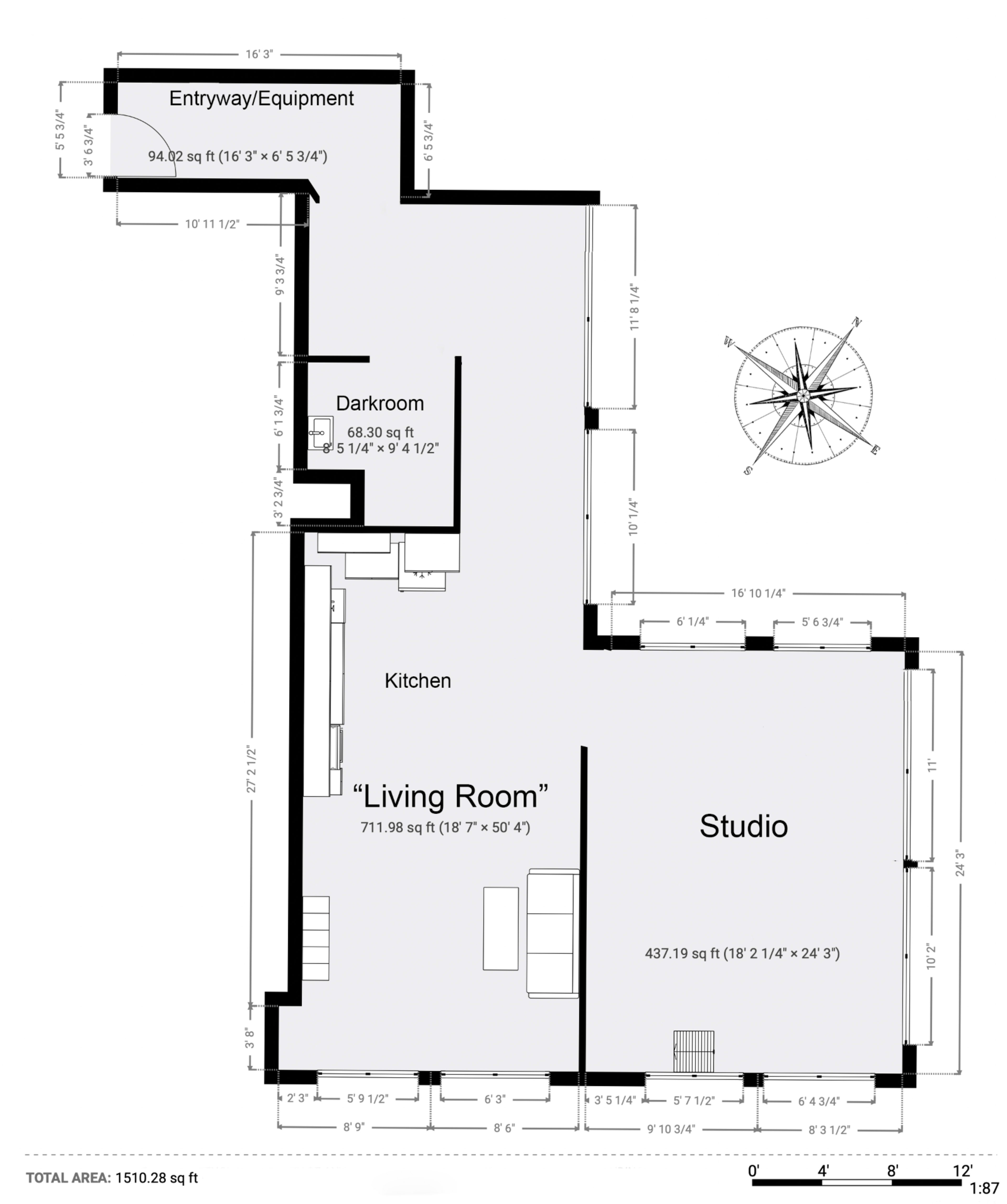 A floor plan layout of a building, featuring labeled areas such as a darkroom, kitchen, studio, and living room, along with dimensions and a compass rose.