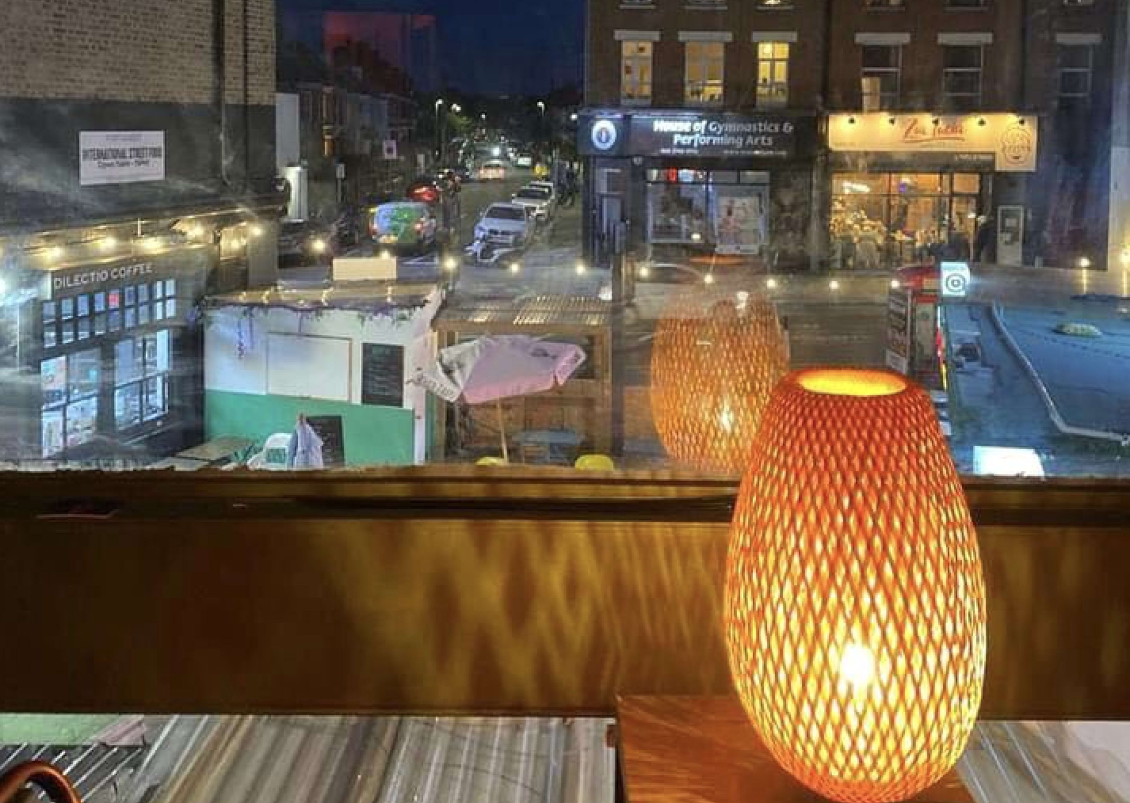 A cool urban first floor cocktail bar and restaurant lounge in a brutalist ex post office building with views over an international street food market Image in Balham, London, ENG