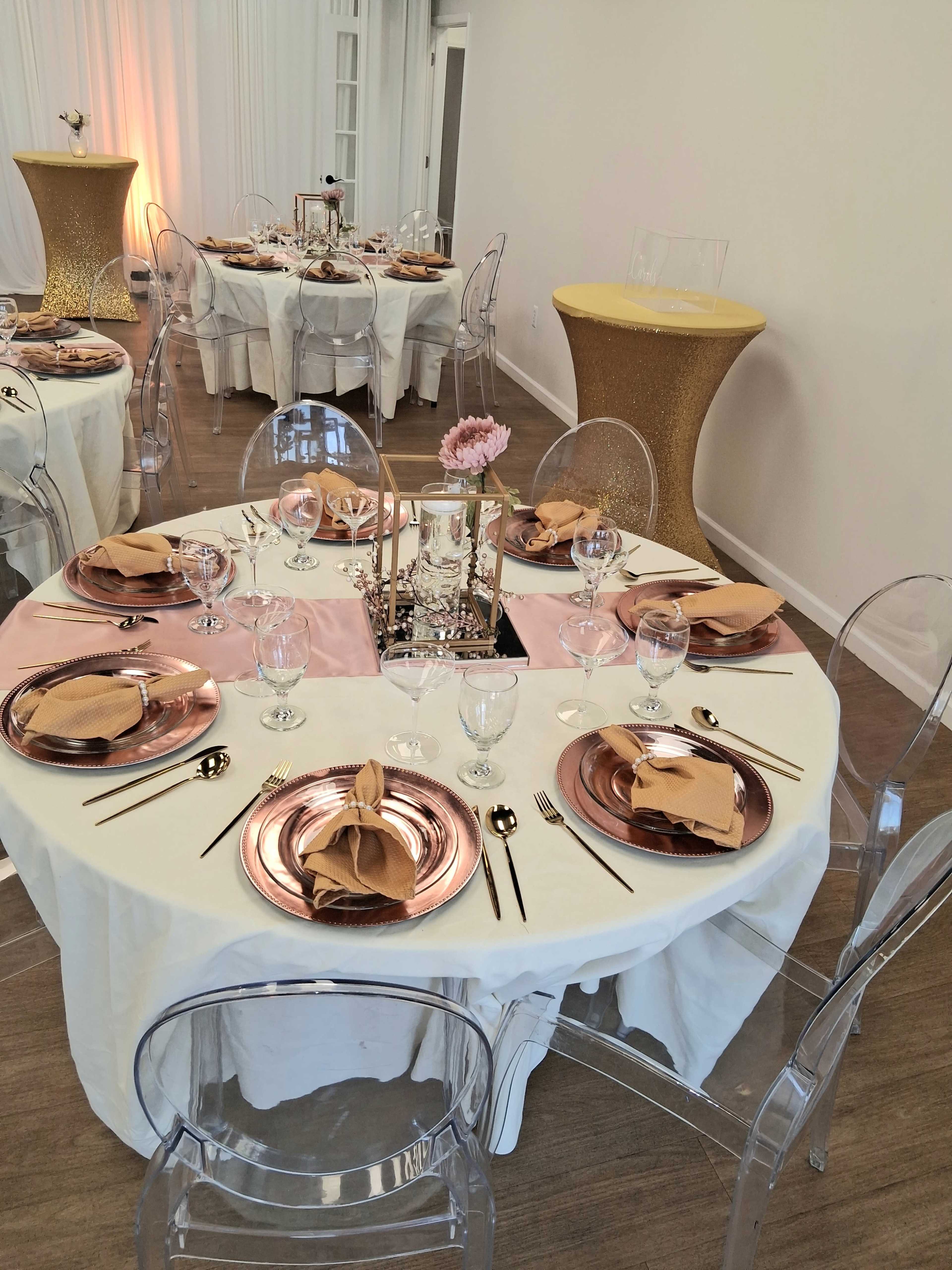 The image shows a dining setup featuring round tables with elegant tableware, including clear chairs, gold accents, and floral centerpieces.