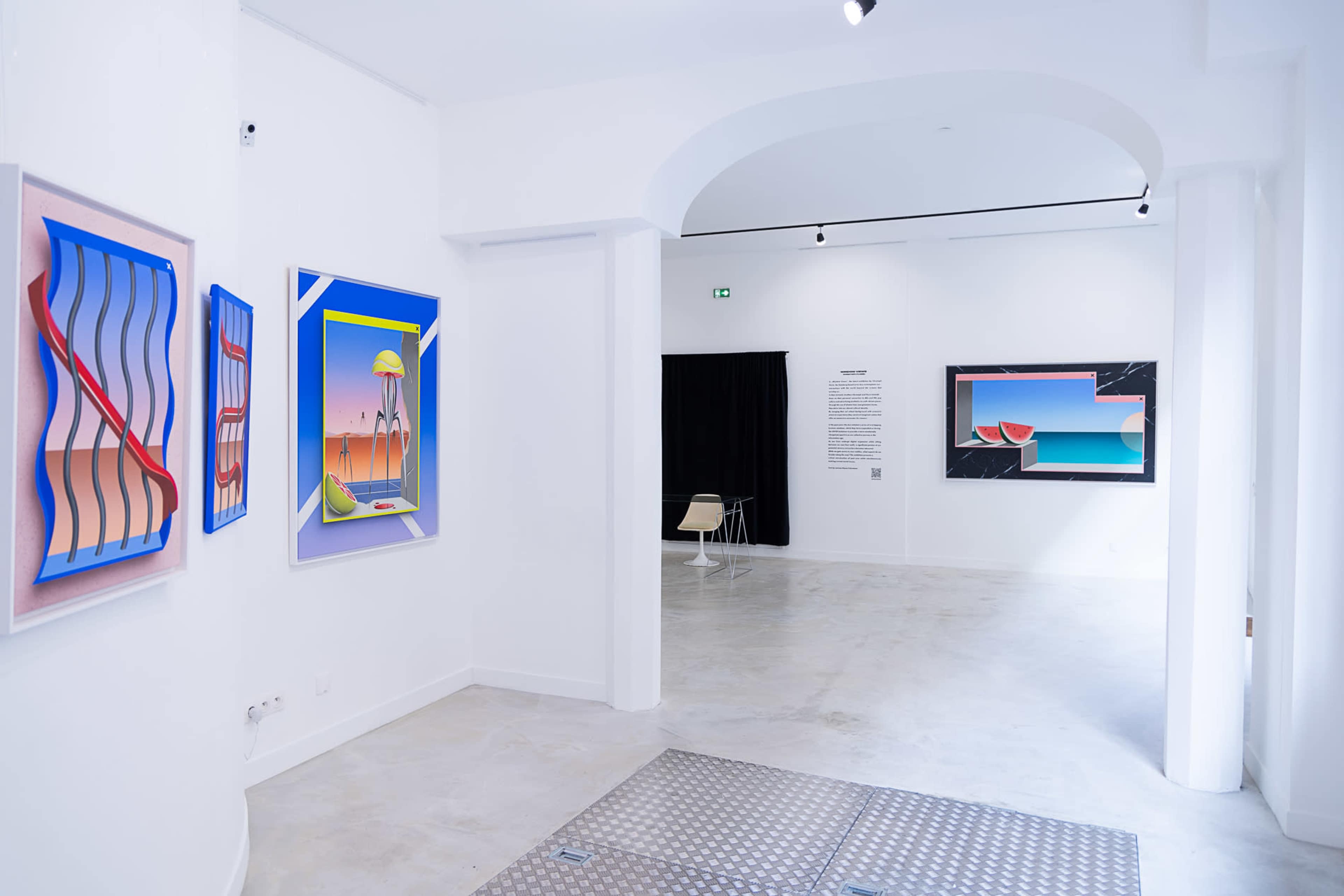 An art gallery interior featuring colorful abstract paintings on white walls, with a modern chair positioned near the entrance.