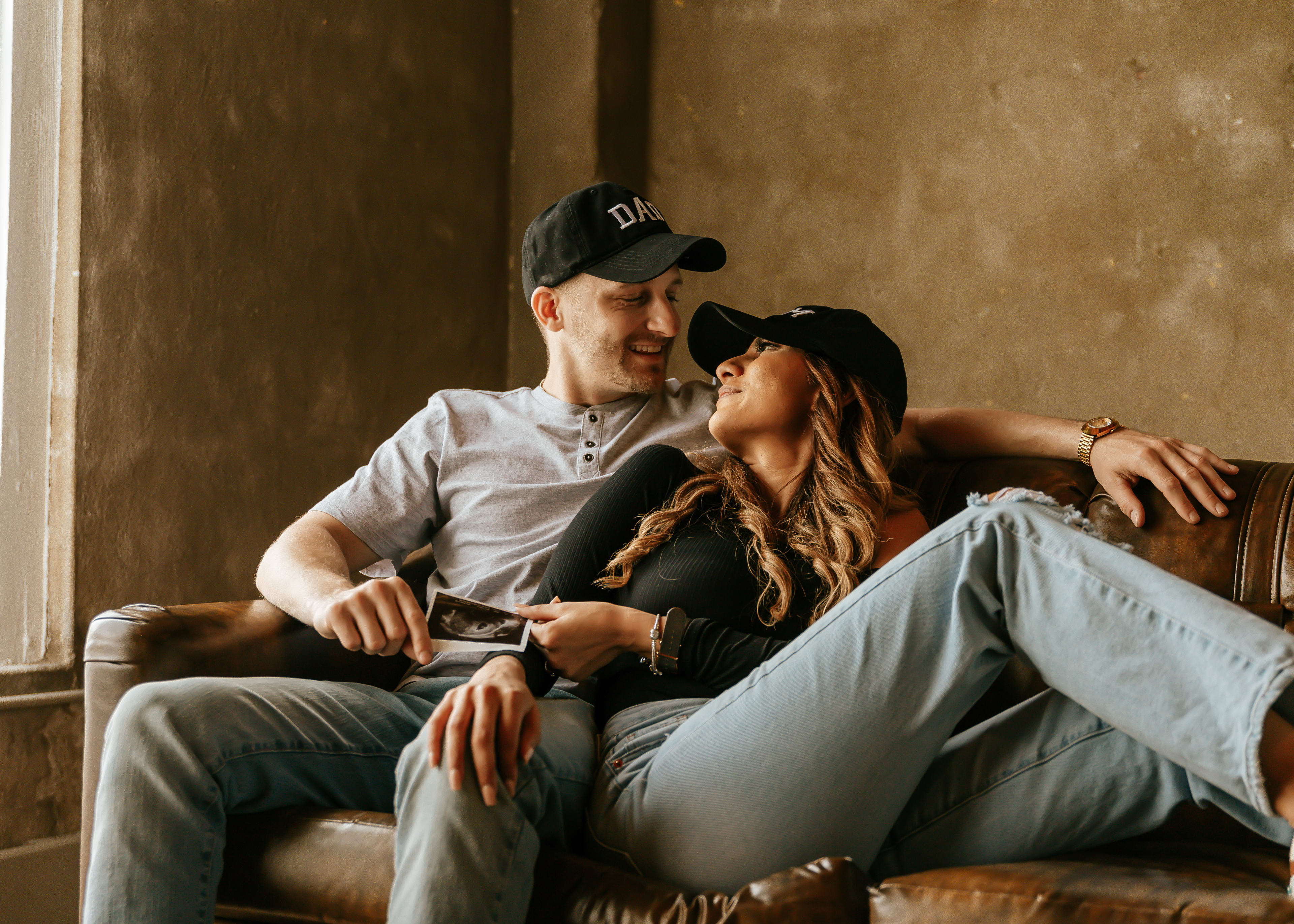 A man and a woman sitting on a couch.