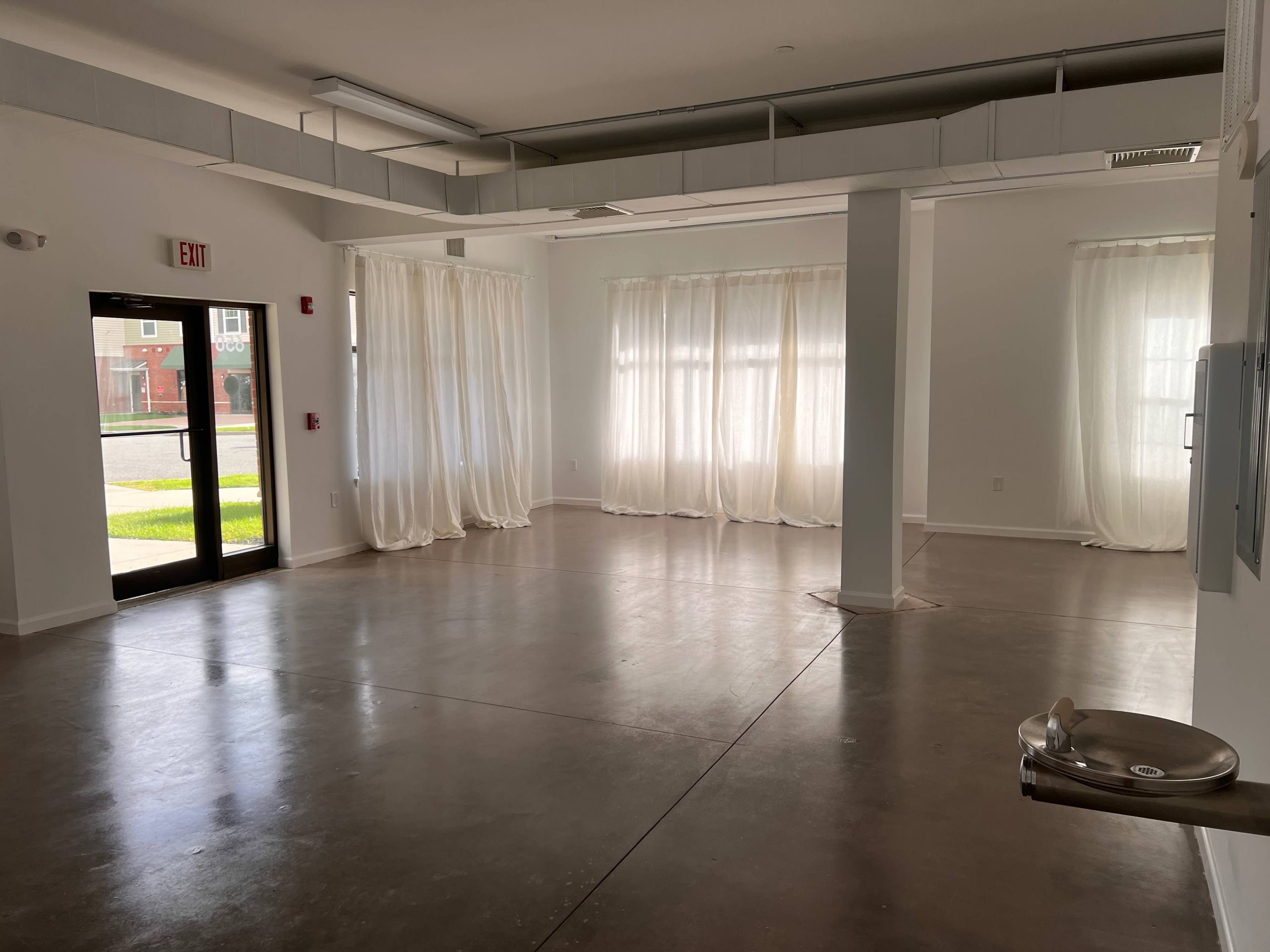 Empty Studio in Residential Neighborhood with Natural Light Image in Brookhaven, Coram, NY