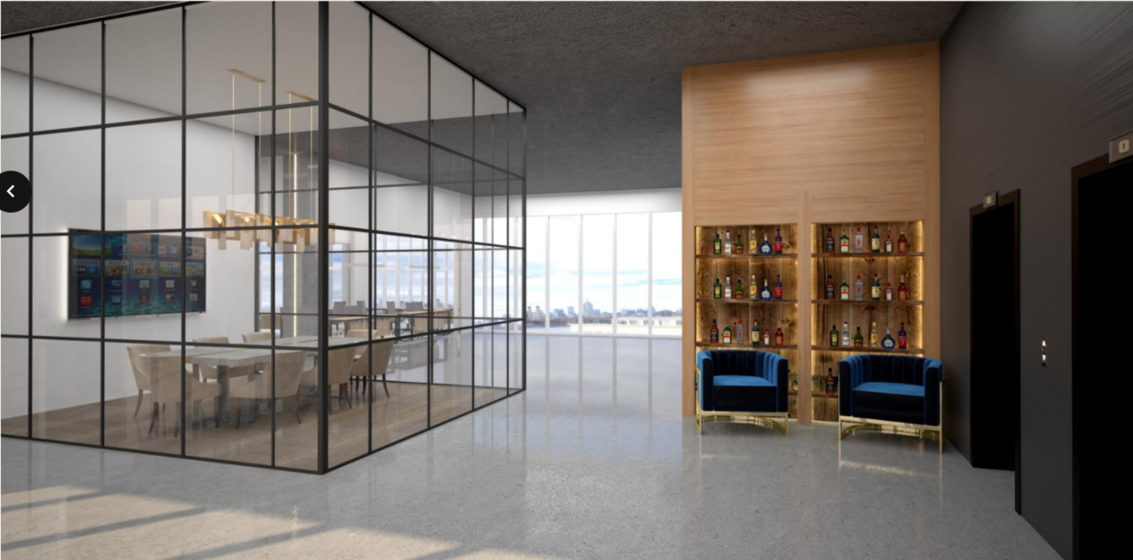 The image shows a modern interior space featuring a glass-walled meeting room on the left, a bar area with bottles on a wooden shelf to the right, and two blue chairs facing the entrance.