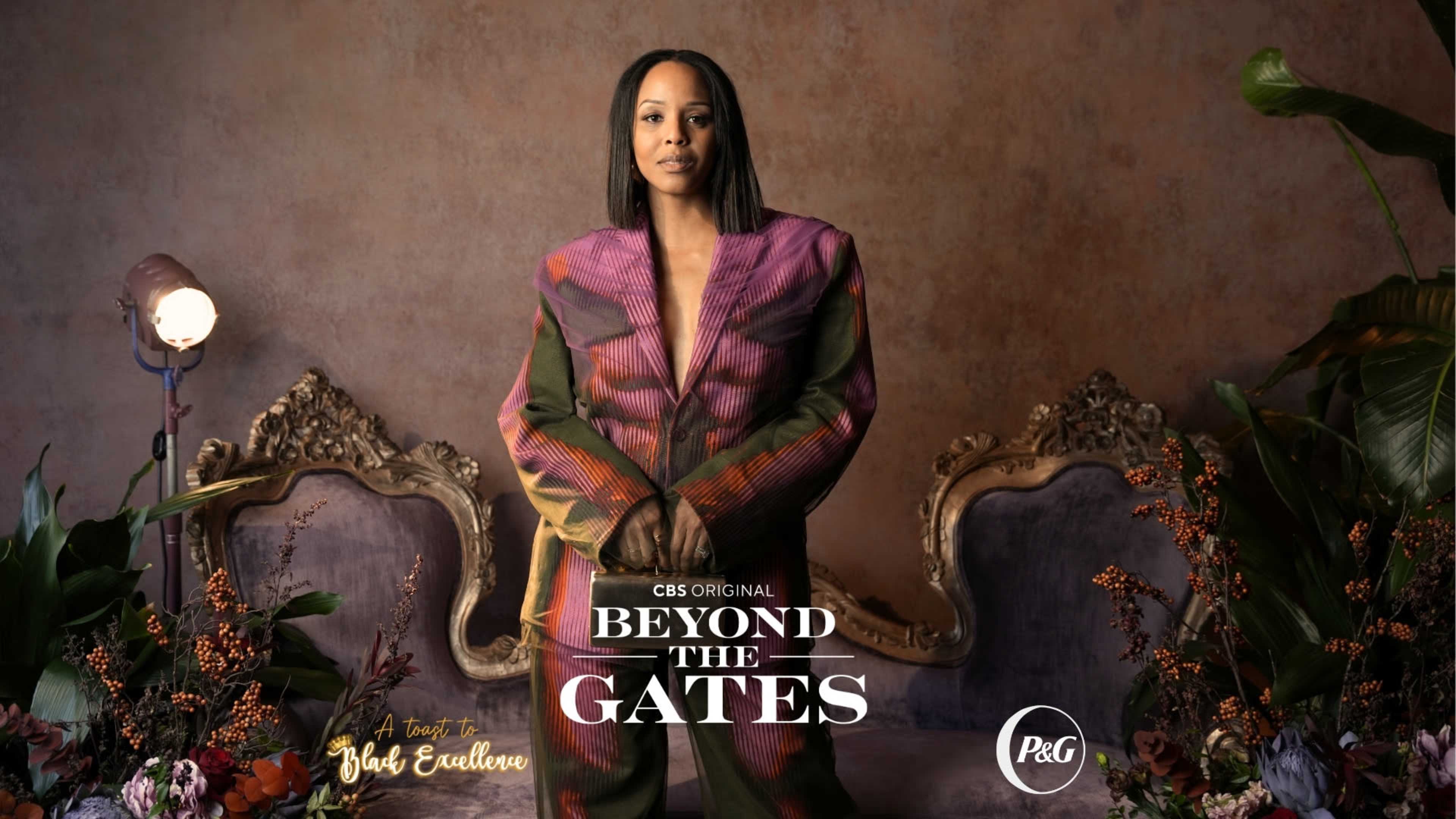 A person stands confidently in front of ornate purple and gold chairs, surrounded by vibrant flowers and foliage, with the text "CBS Original BEYOND THE GATES" prominently displayed.