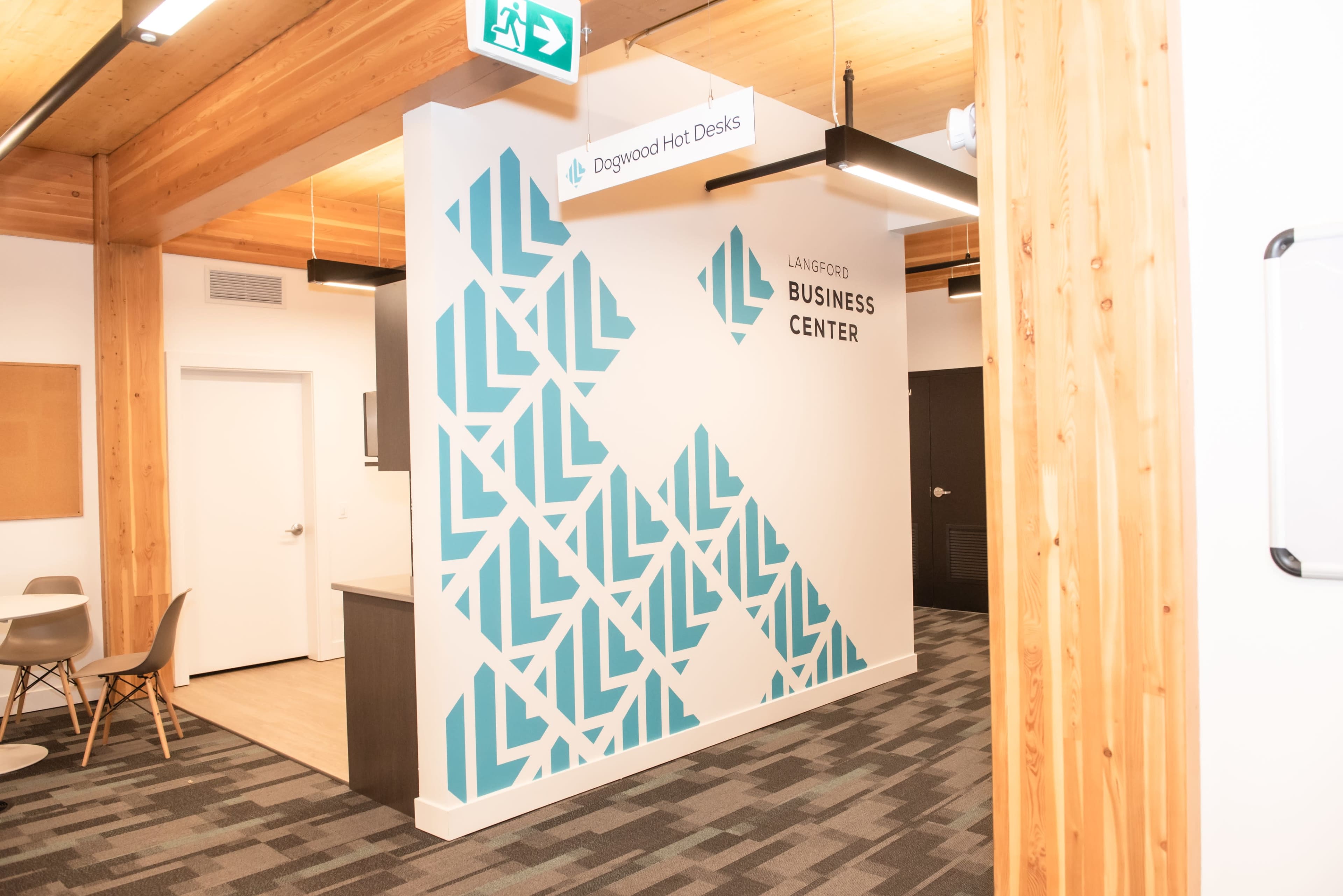 A modern office space featuring a brightly colored wall with geometric patterns, marked as the Langford Business Center.