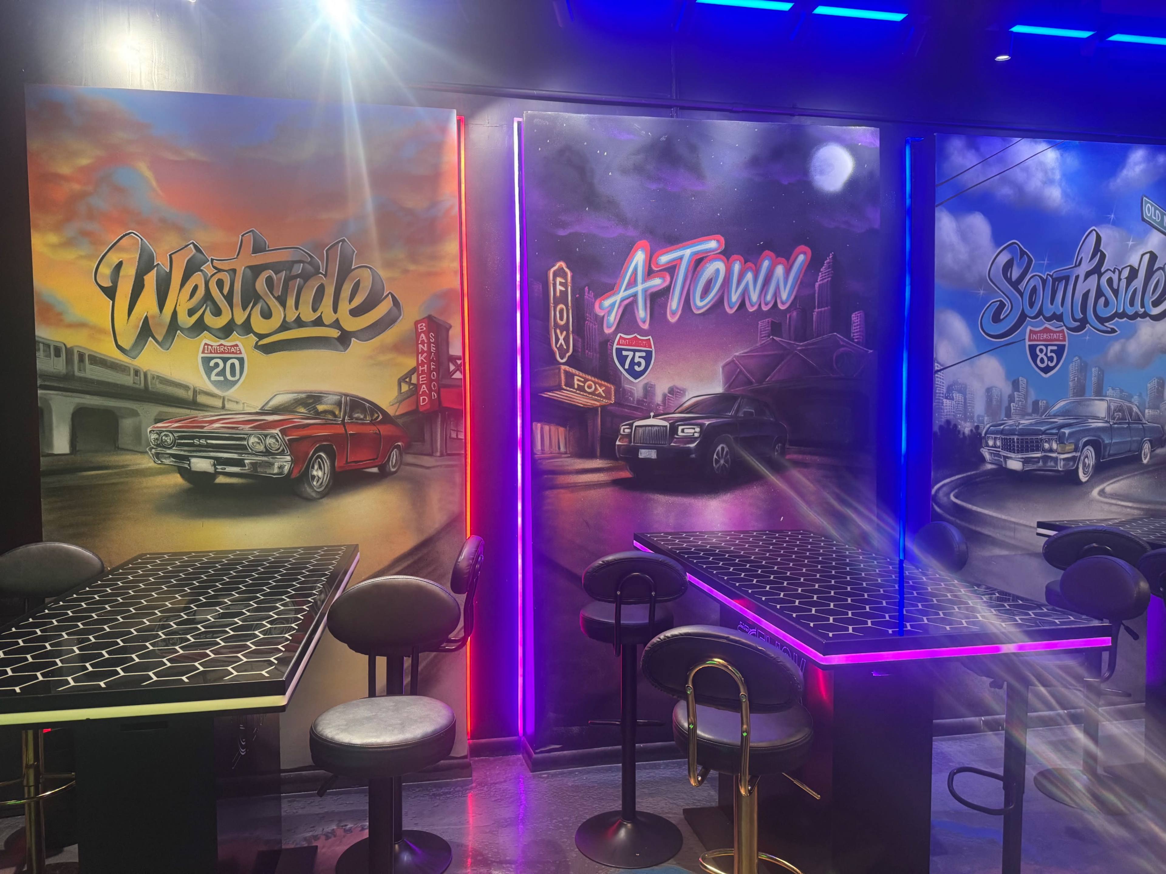 The image features three colorful mural walls labeled "Westside," "A Town," and "Southside," with each depiction featuring vintage cars and vibrant neon accents.