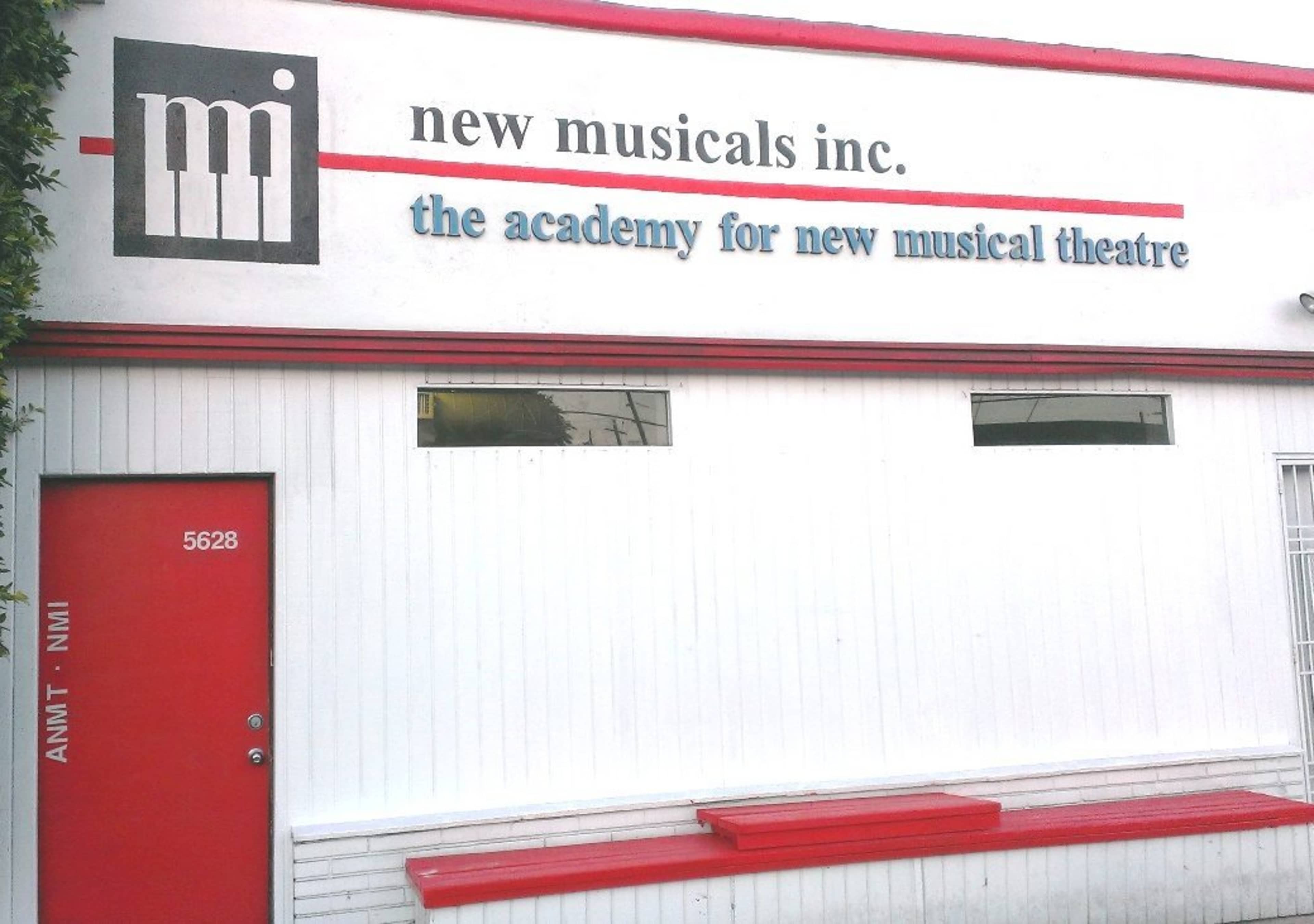 The image shows a white building with red trim featuring the sign for "New Musicals Inc." and "The Academy for New Musical Theatre" along with a red door labeled "5628."