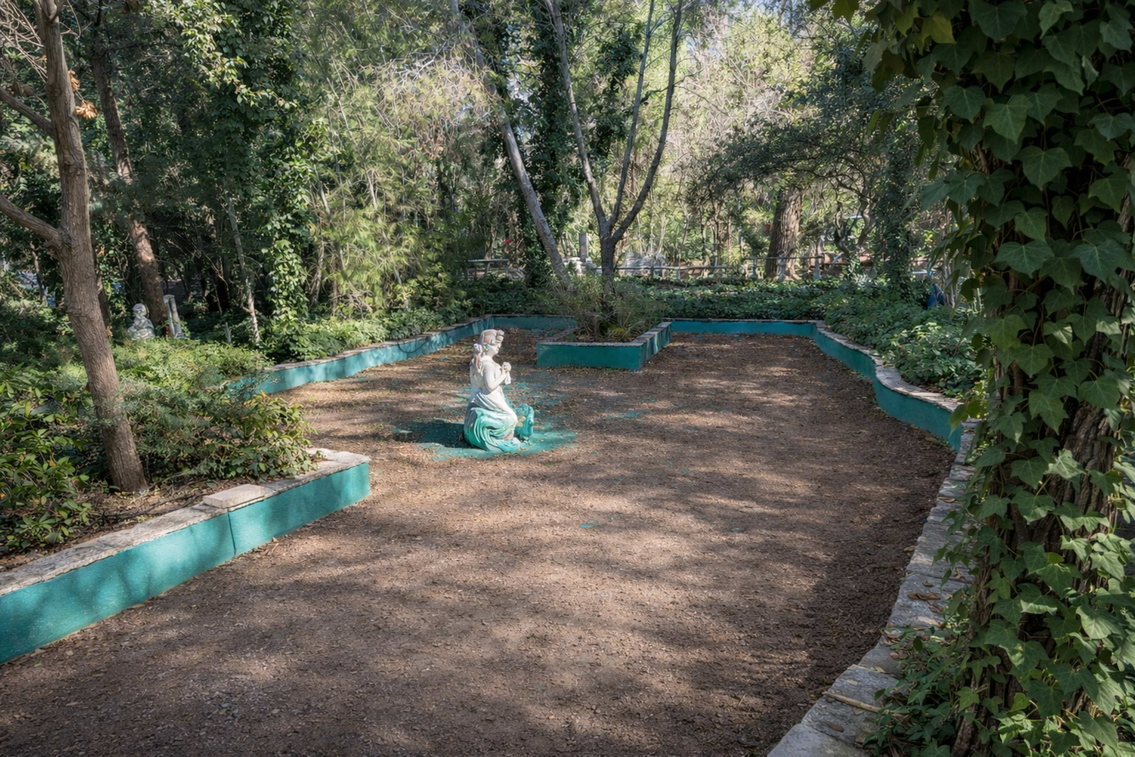 European-Style Garden Courtyard with Lush Greenery Image in Sun Village, Littlerock, CA