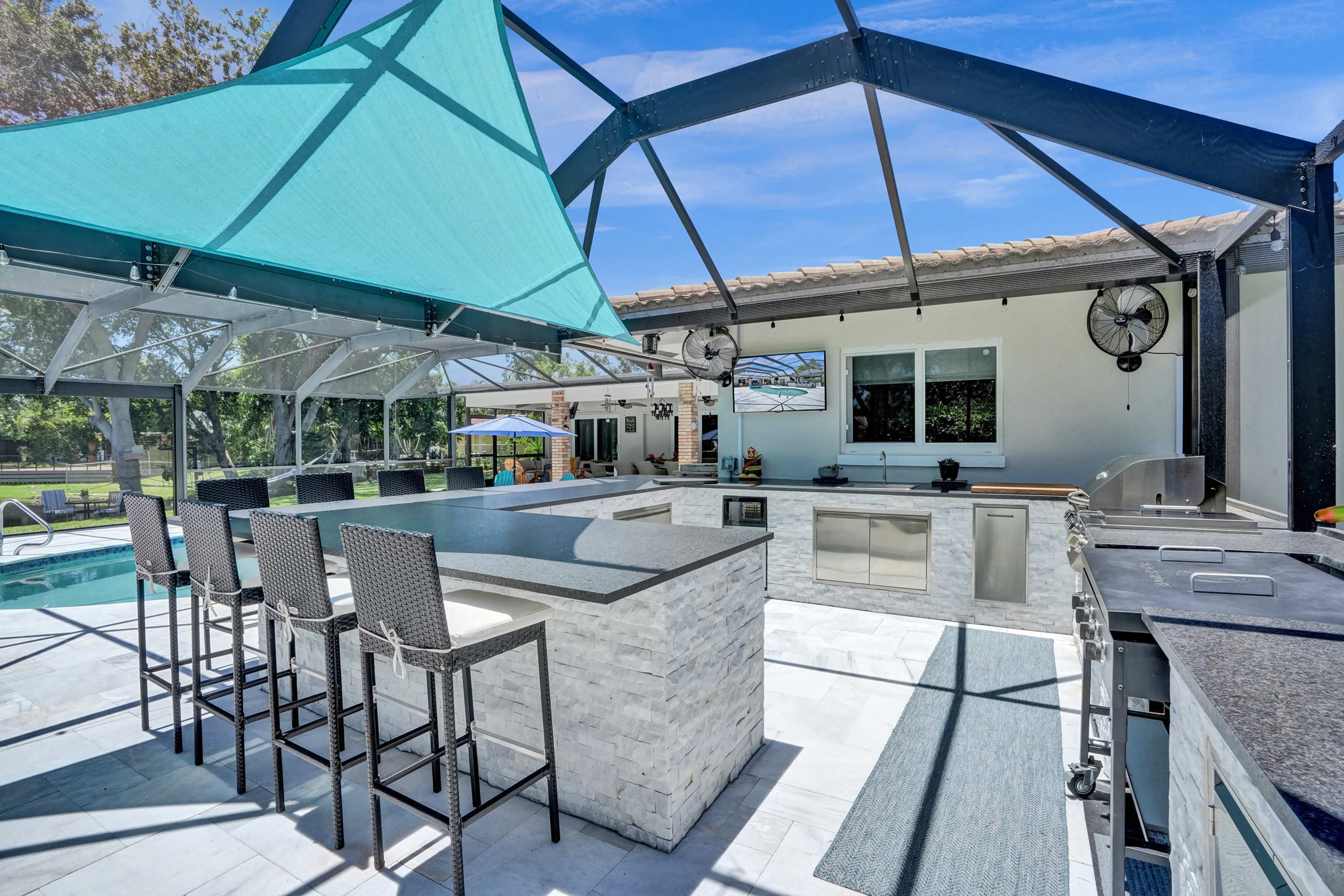 Stunning and peaceful backyard on the lake with a spacious outdoor kitchen Image in Plantation, Plantation, FL
