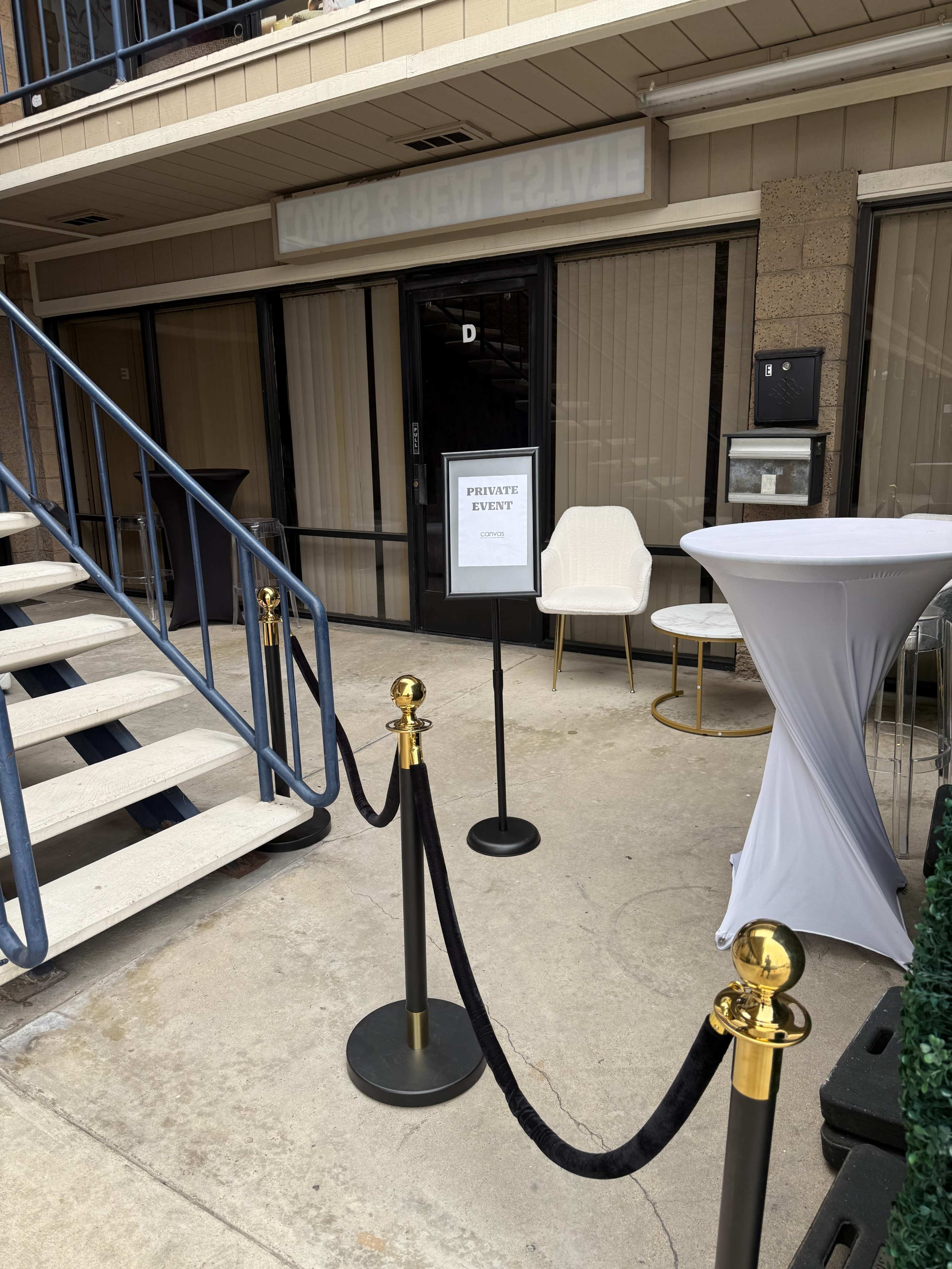 A sign indicating a "Private Event" is displayed near the entrance of a building with a set of stairs and a small waiting area.