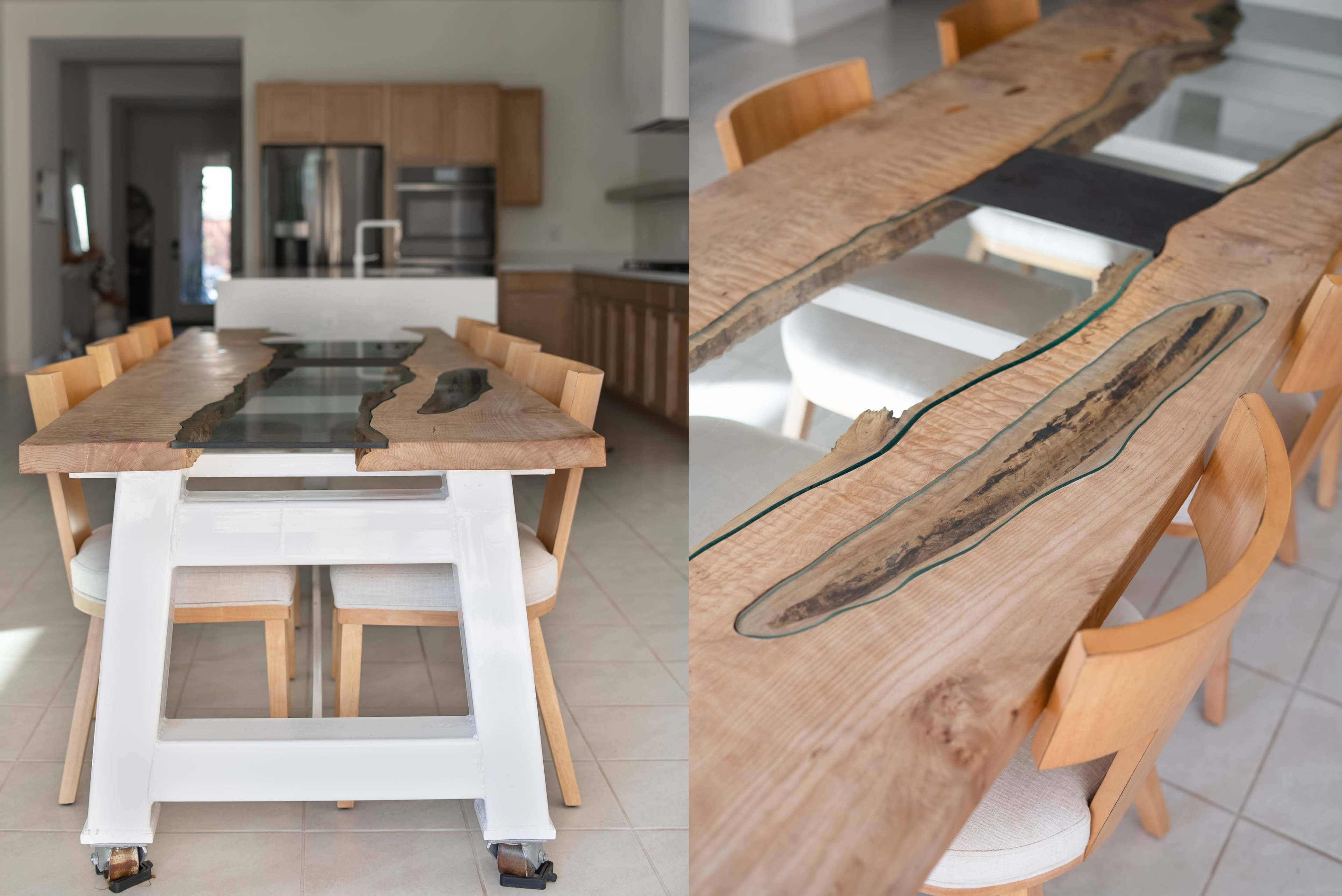 A modern dining room with a wooden table featuring a glass insert and a unique design, surrounded by light-colored chairs.