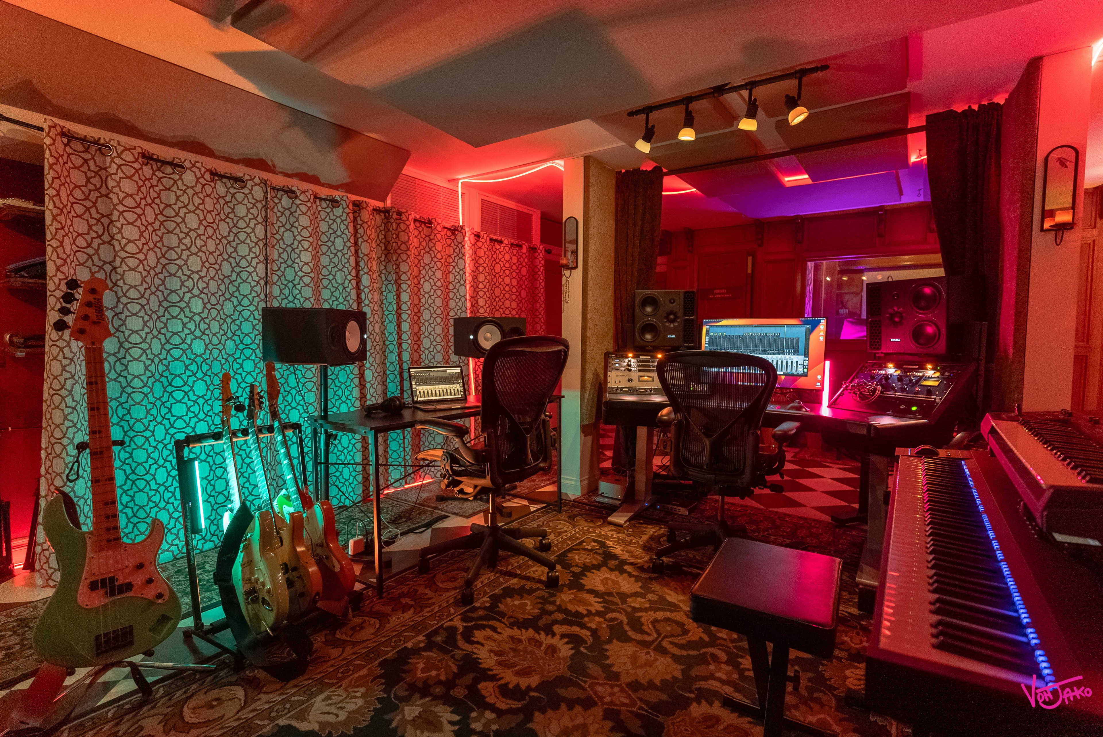 A music recording studio featuring various instruments, sound equipment, and colorful lighting.