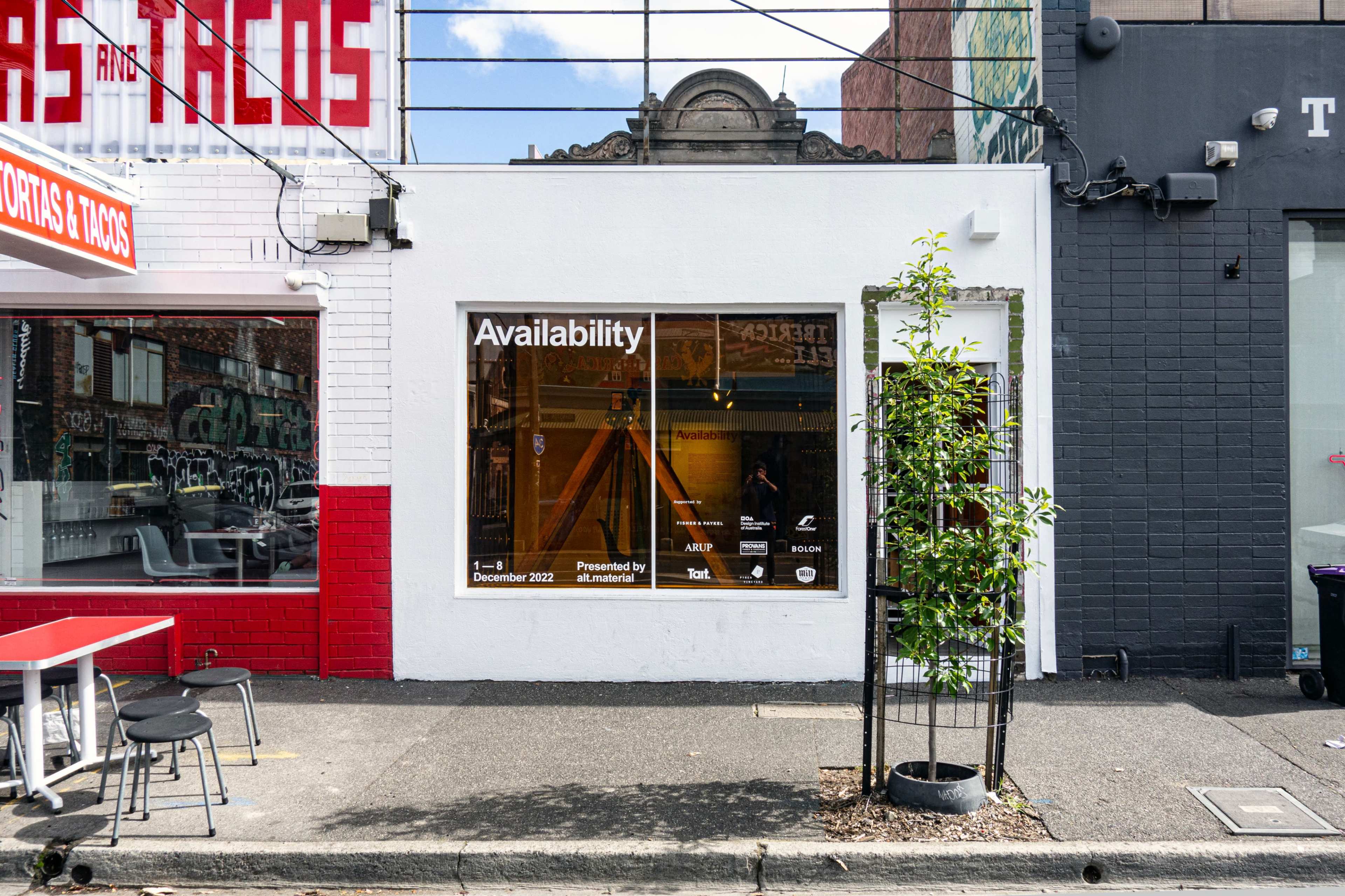A storefront features a large window displaying the word "Availability" along with dates and contact information.