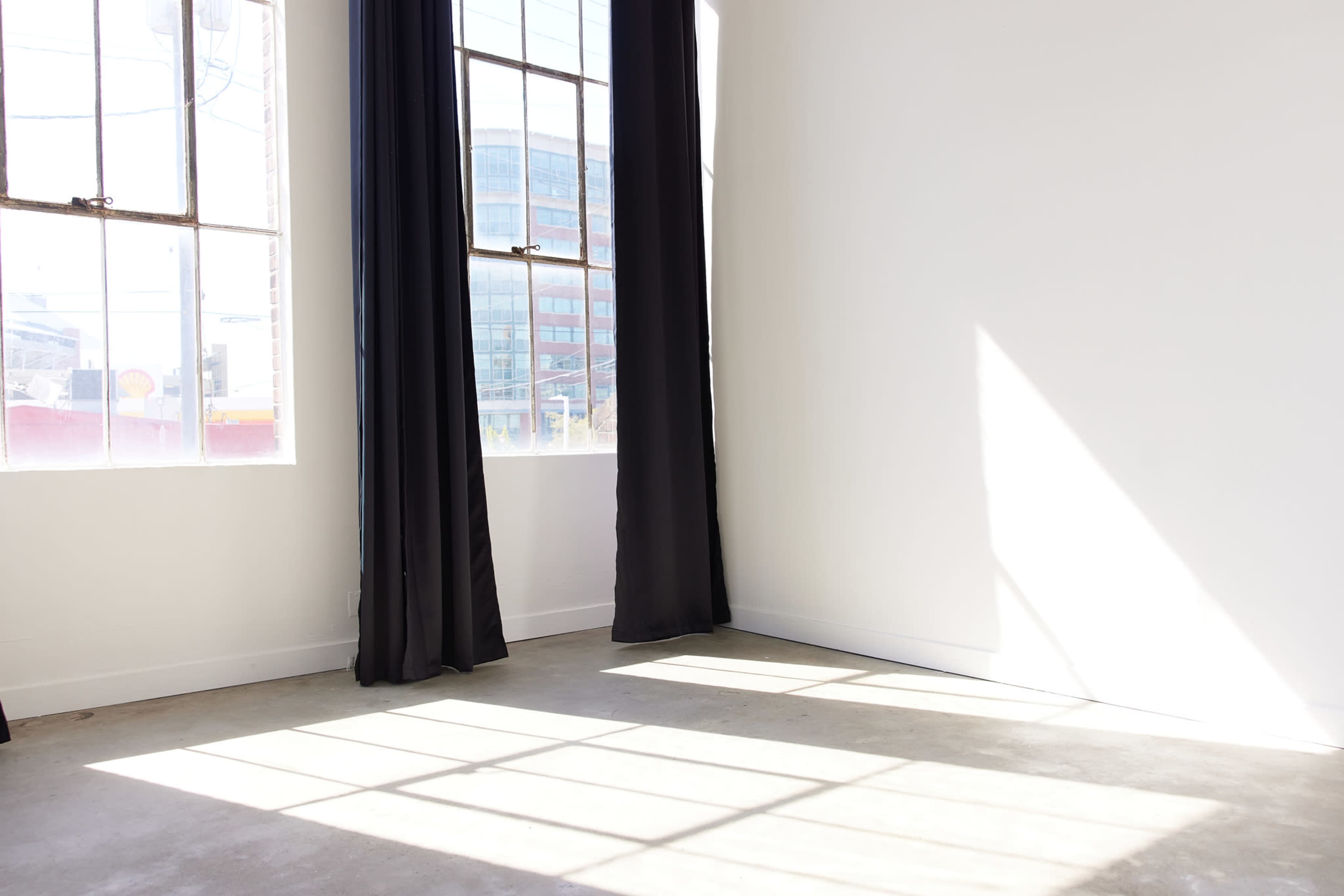 Clean White Studio with Concrete Floors & Natural Light Image in SODO, Seattle, WA