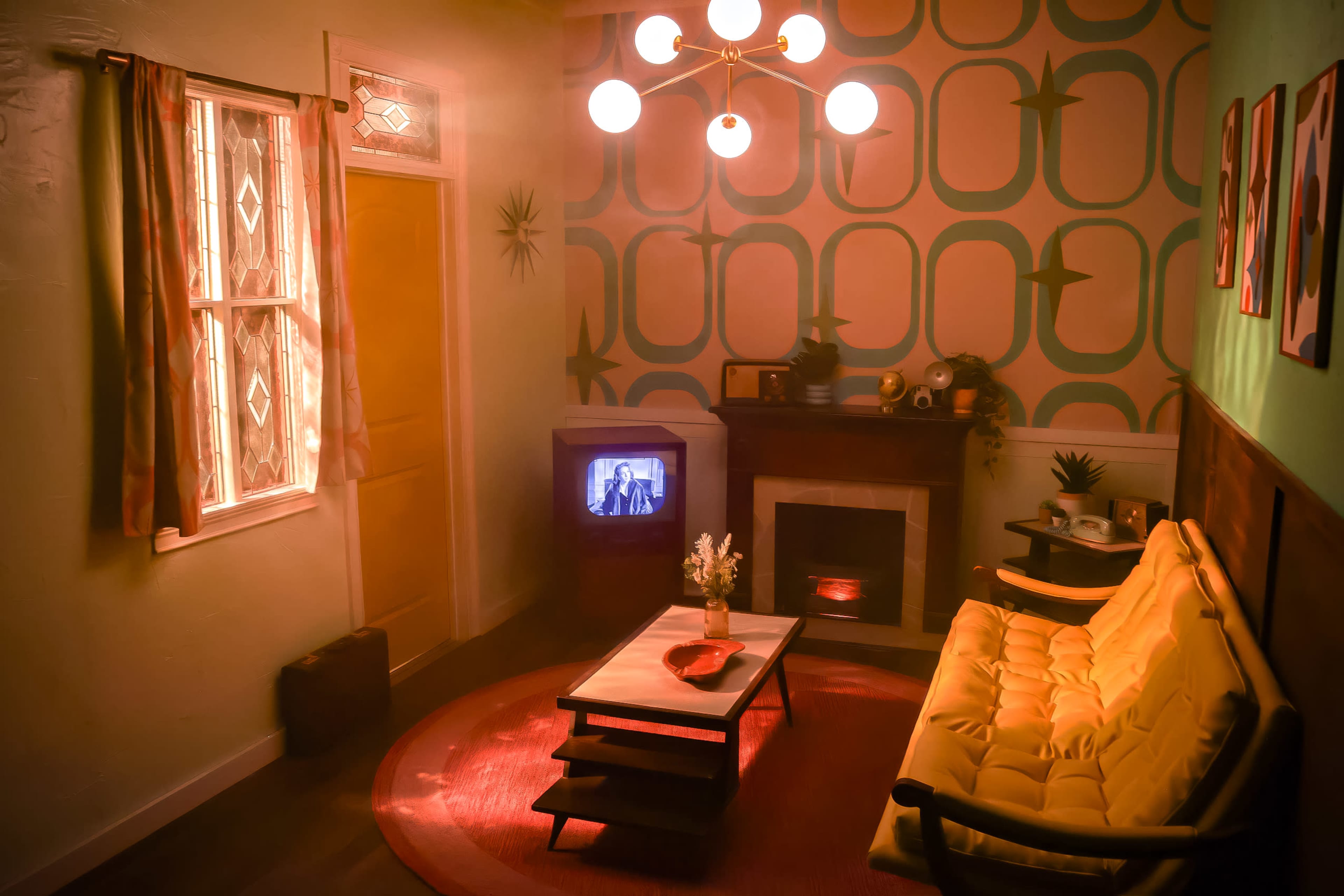 The image shows a vintage living room with a yellow couch, a round red rug, a television displaying black and white footage, and patterned wallpaper.